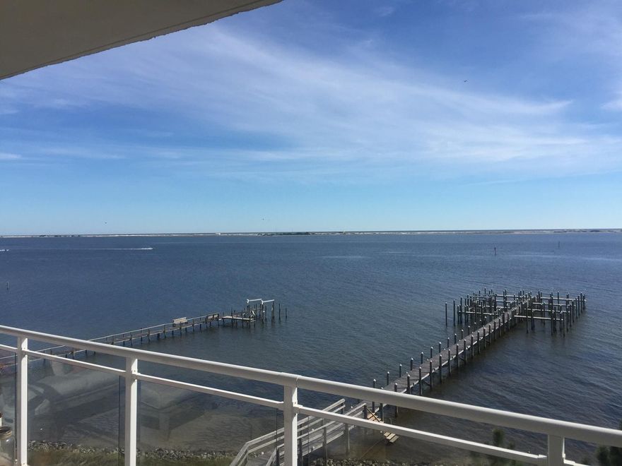 Waterfront living on the Santa Rosa Sound with unobstructed views of Gulf over Santa Rosa Island State Park. Beautiful 3 bedroom 3 bath condo with dock, water side pool, covered parking and elevator service. Gated community that is fully landscaped, fire sprinkler and alarm system. Only items NOT in HOA fee are electric, cable, phone and interior insurance. Tile and carpet floors, granite counter tops, stainless appliances with extended warranty 1 yr, Kohler bath fixtures, owners lockout, and pantry with full size washer dryer hookup. There are no rental restrictions and the property is pet friendly to 20 lbs. All rental since 2009 have been long term.
