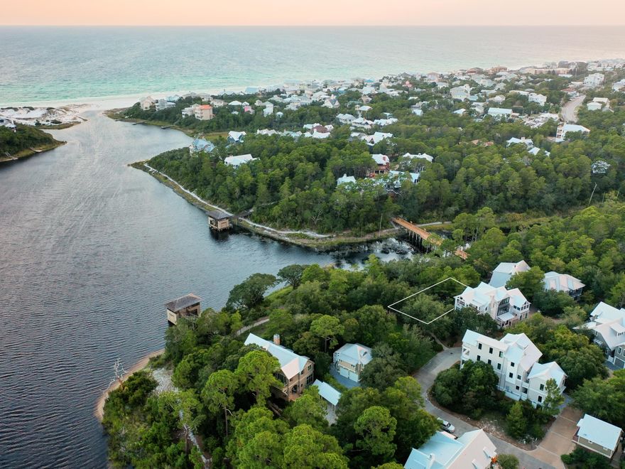 Inspired by the Adirondacks, Draper Lake Coastal Village is nestled between the iconic scenic 30a and emerald waters of the Gulf of Mexico.  Build the house of your dreams neighboring the lush community green space with lake and gulf views, a walkway to the boat house and lake access.  This community of ninety homesites is picturesque and truly unique connecting live oaks, tall pines along rolling hills to marine life in the rare coastal dune lake to the Gulf of Mexico. Sprawled over 40 stunning acres are single family homes with ample amenities including two community pools, covered pavilions, green space, nature trails and bridges along with an impressive 48' viewing tower, two boat houses with secure paddle board/kayak storage and parks throughout this gated master planned development. The unique architecture of the homes with a planned layout adjacent to the green spaces and overlooking the lake provides distinctiveness from other beach communities along scenic 30a. Lot 13-4 is the second lot from the lake and is located in the south east section of the eastern peninsula. Rough house plans by R.W. Lowe Architecture available!