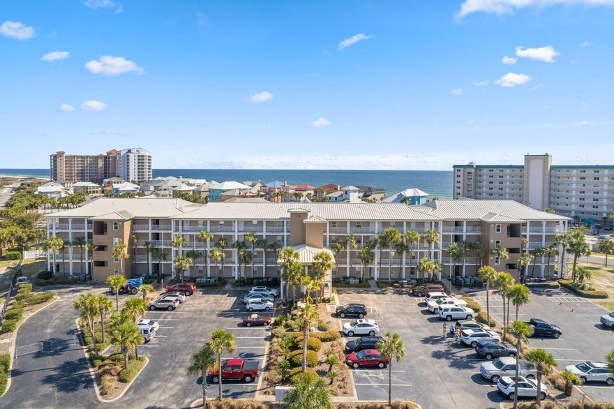 Discover your ultimate beach getaway & seize an incredible rental investment opportunity! Nestled by serene shores & directly across from Grand Caribbean's deed beach access, this fully furnished 2BD/2BA + BONUS BUNKS condo in Perdido Key invites coastal charm embrace. Step into comfort & modern allure as you enter ground-level corner unit, with natural light, extended patio & over $16K of NEW HURRICANE SHUTTERS. Ambiance enhanced by stylish fixtures & contemporary furnishings, ensuring every moment is infused with relaxation & luxury. Kitchen boasts resurfaced cabinets adorned with stone backsplash, alongside gleaming stainless-steel appliances. Delight in convenience of stacked washer/dryer tucked away in kitchen for ease. Indulge in rest & rejuvenation within well-appointed bedrooms.