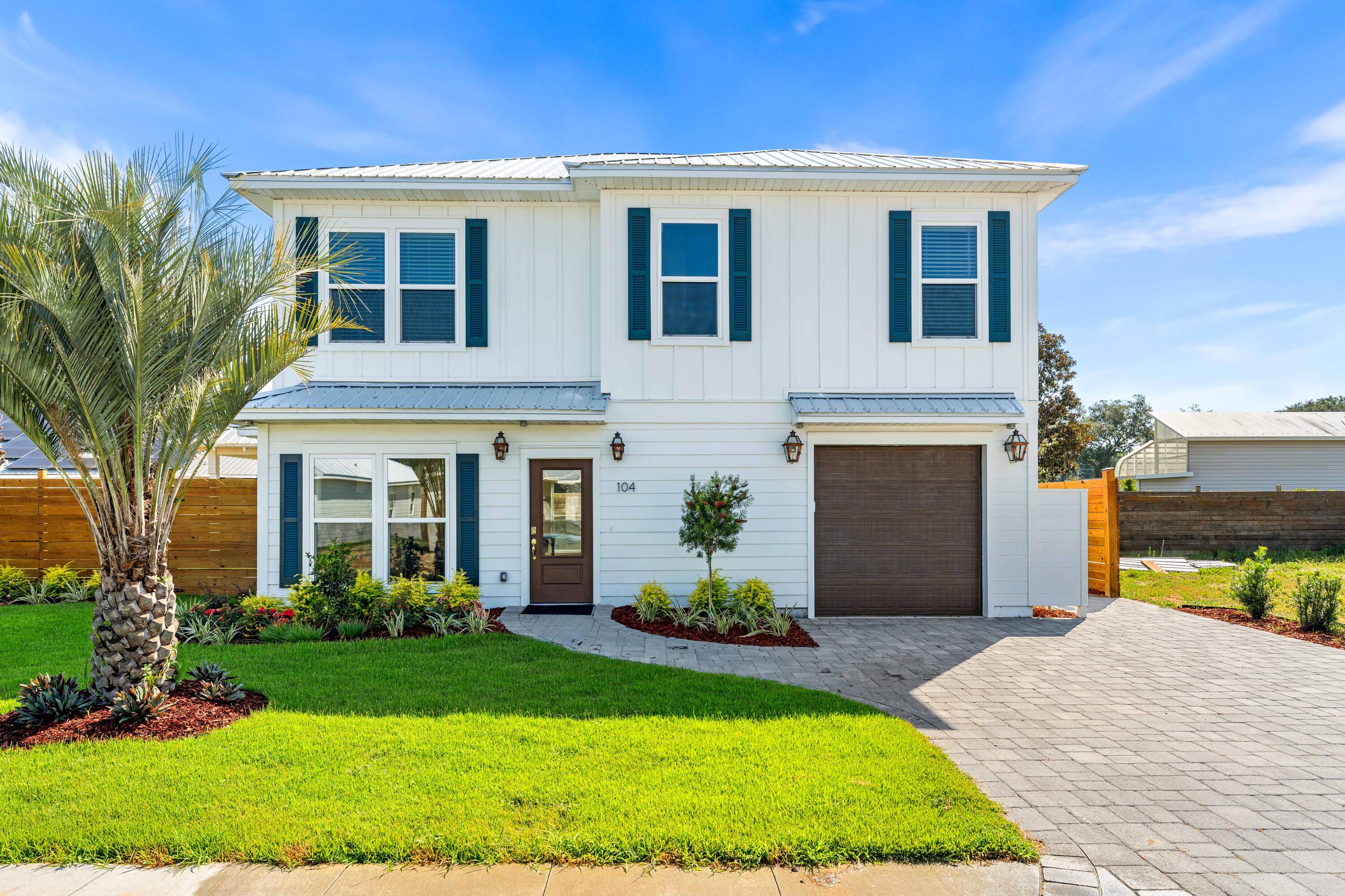New Construction in Old Destin is hard to find, so come discover the best of both worlds at The Destin Cottages, a new gated neighborhood of just 12 Coastal homes tucked away in the heart of one of Destin's heritage communities and only minutes from EVERYTHING Destin is famous for- the sugar white sands of the beach, the Bay, the Harbor, the Pass, and even Crab Island. Hop on your golf cart to grab lunch, catch the floating tikis to Crab Island less than a mile away, ride your bikes 3 blocks to school at Destin Elementary or stroll over to Harborwalk for a casual dinner - it's all in your backyard until you are ready for the quiet bliss of your coastal cottage retreat. The gated community features an entrance on Kelly Street and exit off Sibert just seconds from the Destin Pass, but world's away. Elegant paver driveways, farm house chic brick and cement board exteriors, enchanting natural gas lanterns on each home add to the coastal charm along with lush landscaping. Each home features gas appliances including a full appliance package with ice maker and water hookup for additional ice maker in the garage; on demand water heaters are standard.
These coastal homes feature:front porch gas accent lights, Navien tankless instant water heaters with recirculation pumps, gas fireplaces, metal roofs, sentricon stations, golf cart pads, rain
shower in the primary bath, soaker tub, wood shelf pantry and luxury vinyl flooring throughout. The HOA maintains the front yard and all homes are on a well irrigation system managed by the HOA.
If you are looking for a new home within a coastal retreat community in the revitalized Old Destin area, come let the charm of The Destin Cottages whisk you away.