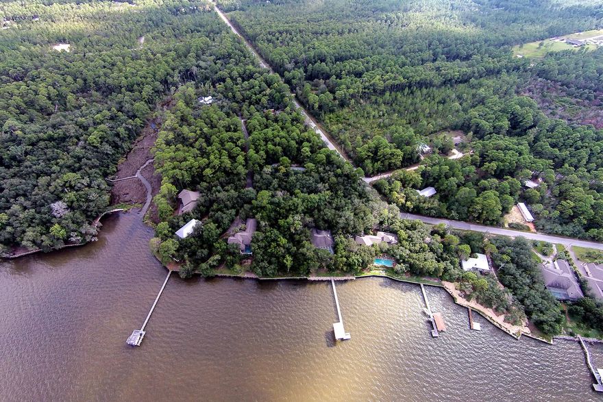 This lot is situated in a quiet neighborhood with a few restrictions on building. It backs up to a small canal that leads into the bay, where you can put in your canoe or kayak