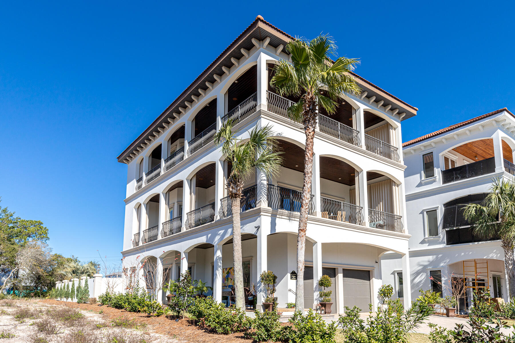 Nestled on 30A's peaceful west end, this immaculate 5BR/4BA home overlooks Topsail Hill Preserve State Park with 3rd floor views of the Gulf of Mexico. This home is perfectly suited as a full-time residence, second home or as a rental property. No detail has been overlooked in this Mediterranean style home with standout finishes including 12-foot ceilings on every floor, elevator, hardwood and travertine flooring, custom cabinetry and designer lighting. The welcoming and large living room includes a coffered ceiling, wrap around wide porch and a gas fireplace while the fully equipped kitchen offers commercial grade stainless appliances including a Sub-Zero refrigerator and gas range. Three large porches provide ample room to enjoy the warm Gulf breeze, and the rear covered porch overlooks