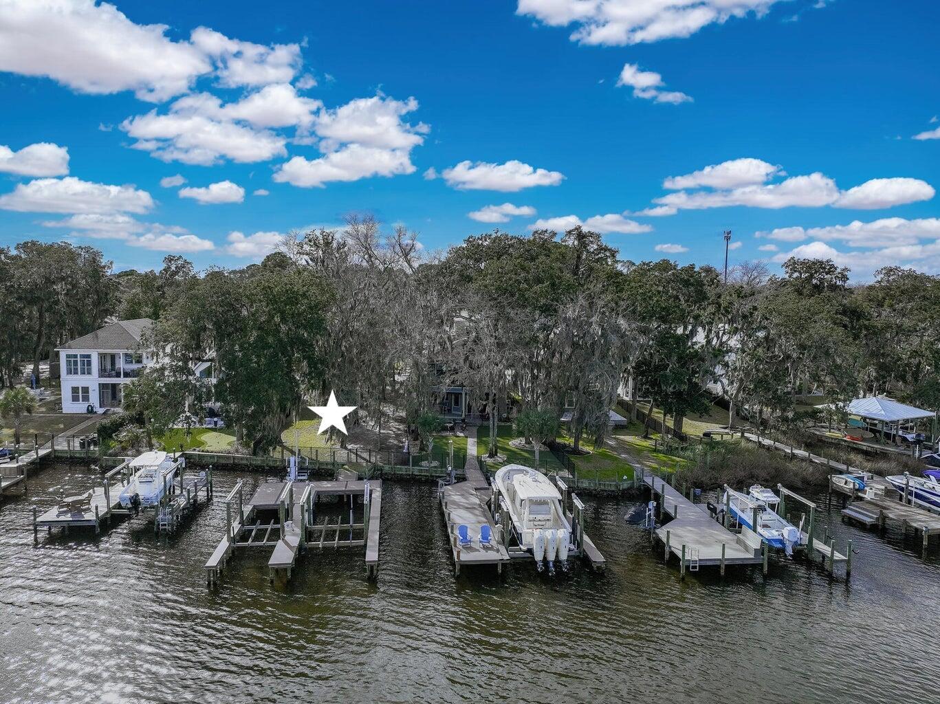 Discover the beauty and tranquility of waterfront living with this stunning bayou front lot located in Sacred Oaks subdivision on Mack Bayou. This unique property offers expansive views over deep water and is graced with majestic 100 year oaks. This lot offers 2 boat slips and 2 lifts as well as a wave runner lift. The dock is also made with high-end TREX decking for added durability. Sacred Oaks is conveniently located near Grand Blvd, Sacred Oaks Hospital, Sandestin and 30A.