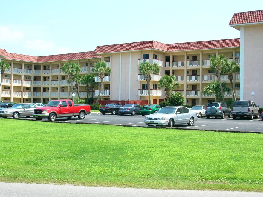 Golf course condo living at it's best! This is a 2BR/2BA ground floor and END unit condo located in Colony Club in between the par 3 and 18 hole golf courses. You can walk to the Holiday Golf Course clubhouse and driving range from your own front door Updated with wood floors and beautiful furnishings (which do convey), you'll love the screened back patio with small storage closet over looking the common area to the community pool. Located just East of Pier Park and only minutes to the beach. All info approx and must be verified by buyers if important. NO SHORT-TERM RENTALS ALLOWED.