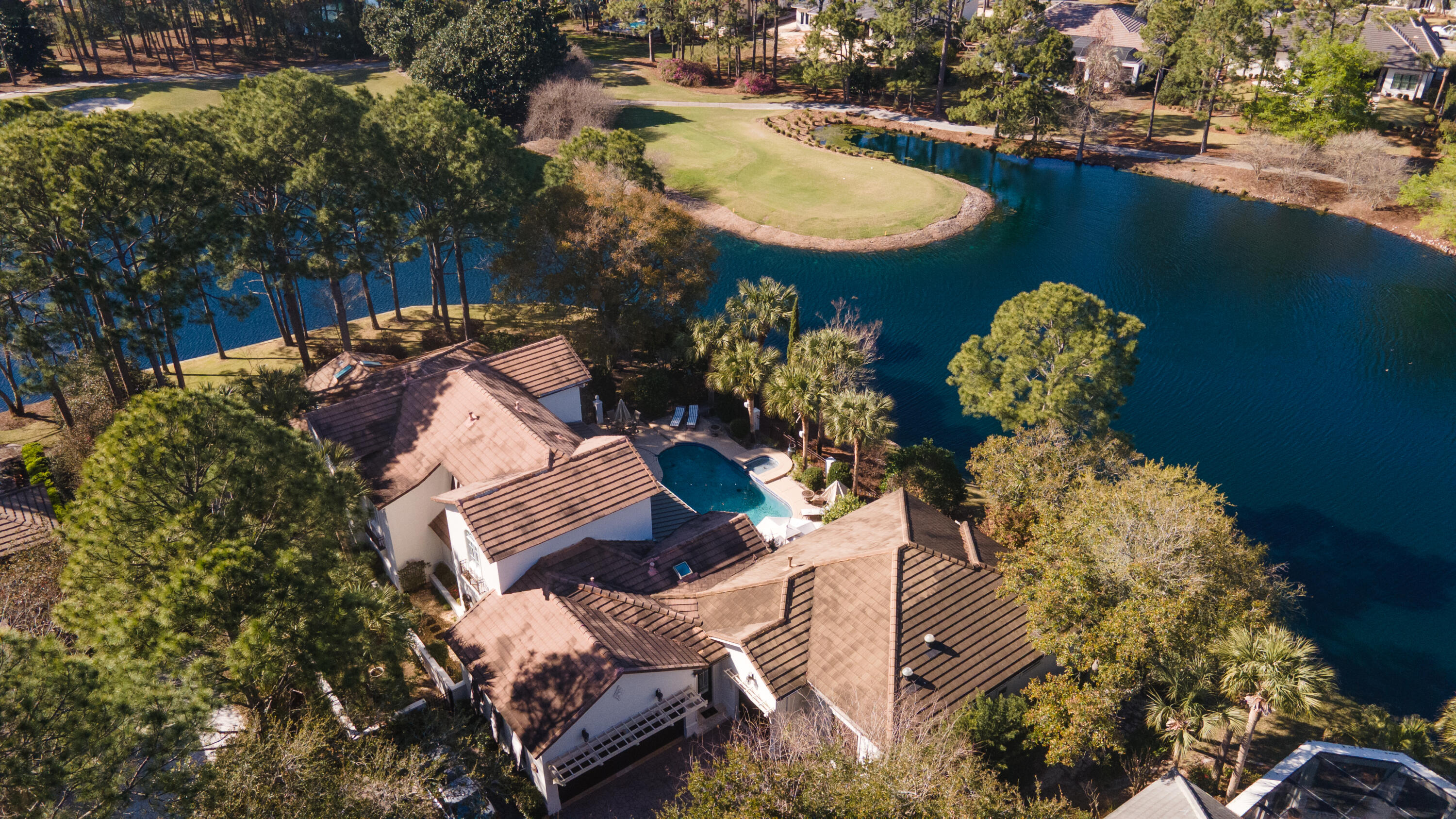 Privacy and Luxury is what 1533 Island Green Ln has to offer. This exquisite home in the gated Island Green neighborhood in the Sandestin Community showcases the perfect blend of spaciousness and comfort. This expansive 6,870 sq ft home has five spacious bedrooms and four and a half elegantly appointed bathrooms, this corner lot in Island Green offers ample space for your lifestyle needs.Step inside to a grand foyer that leads to a stunning living area, adorned with chandeliers and bathed in natural light from the bay and floor-to-ceiling windows. The hardwood and carpet floors add warmth and sophistication throughout the home. The gourmet kitchen is a chef's dream, featuring an island kitchen with granite countertops, a breakfast bar, and top-of-the-line appliances including a stove, refrigerator, and dishwasher. Retreat to the main floor primary suite, complete with a walk-in closet and a luxurious marble bathroom featuring separate vanities, two walk in showers, a double sink, and a bidet.
Outdoors enjoy the private pool and expansive outdoor space. Sit on the water and watch the world renowned golf course of Burnt Pine come alive, or hop on over and play for yourself. Additional features include a golf cart garageThis fully furnished home is a rare gem, offering a lifestyle of elegance and convenience. Don't miss the opportunity to make this exceptional property your new home! Call today!