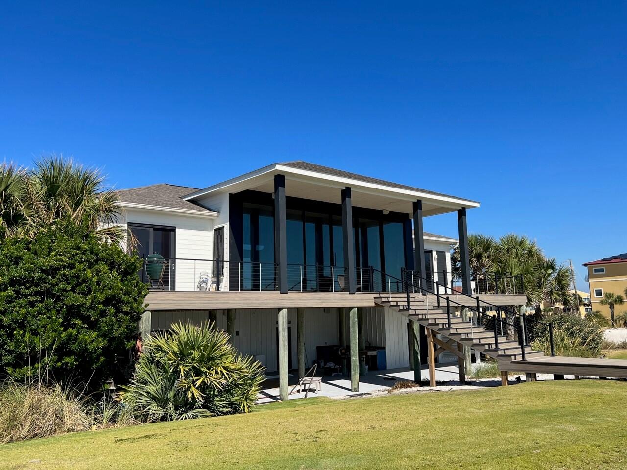 Gulf front! Completely remodeled this year. This stunning home is the ultimate in beach front living. Walk in to find unobstructed and panoramic view of turquoise water and white sand through 40 feet of glass sliders. When all sliders are opened, the opening is approximately 30 feet. The home features an open floor plan with a large living area flowing into the kitchen and the dining area. The fantastic kitchen features 2 Sub Zero refrigerators, a 6 burner Wolf gas stove, other Wolf appliances and a large kitchen island. The primary suite features sliders and access to the Gulf front covered patio. The primary suite includes a luxurious bathroom with two vanities, a generous shower and a fabulous walk in closet. There are 3 other spacious bedrooms each with an en-suite bath.