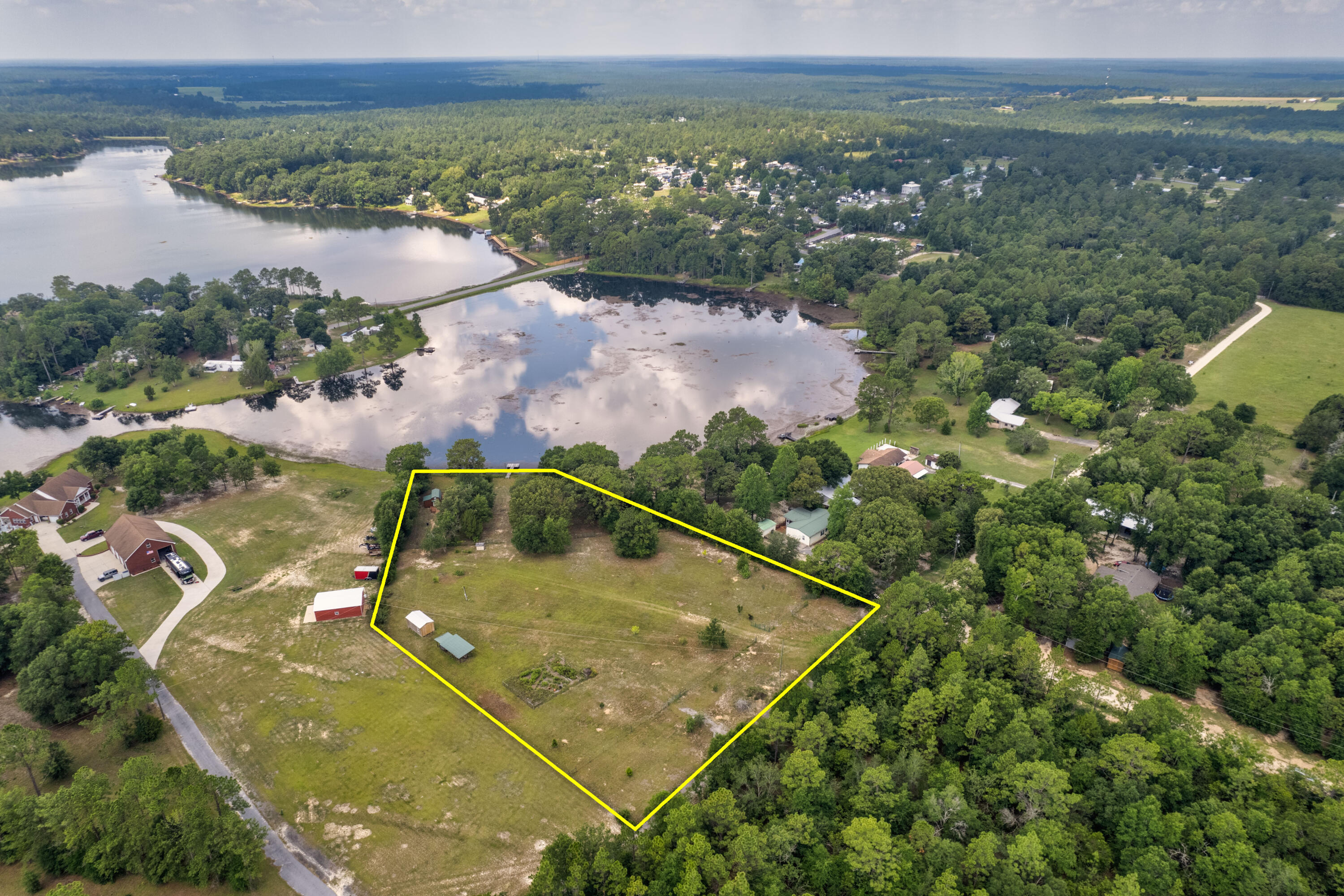 Welcome to 397 Paul Road, the epitome of lakefront living. This exceptional 2.91-acre (flood zone-x) property located on the north side of Kings lake in Defuniak Springs. The property features a build out with two lofts and a full size bathroom perfect for short term rental or weekend getaway. Plenty of storage with a full sized pole barn, Graceland Corner Porch Cabin and fully fenced lot with potential for horses or animals.