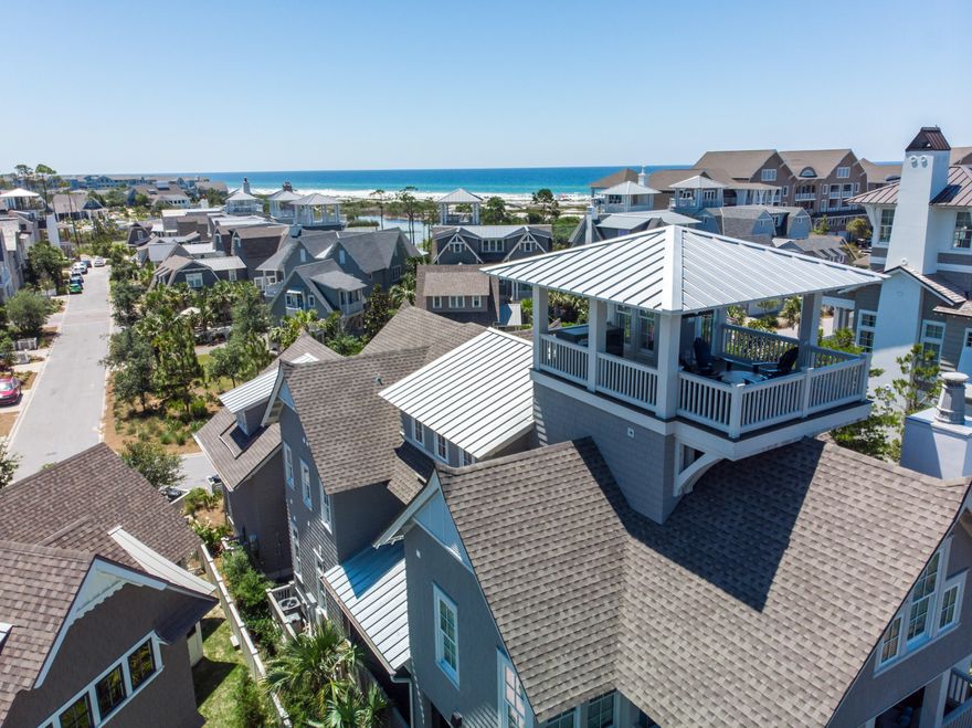 Truly epitomizing the WaterSound Beach lifestyle is a beautiful coastal retreat with professionally designed interiors & breathtaking Gulf of Mexico views. Taking full advantage of the prime location the home borders both Linear Park & Yacht Pond. This residence boasts an open floor plan, wide plank reclaimed hardwood floors, elevated wooden beam ceilings & a plethora of windows plus nano wall that allow in the multitude of natural light. The main level offers seamless indoor & outdoor living with the family room opening to a large screened porch providing additional dining space & fireplace surrounded by seating to enjoy endless beach days. A private jacuzzi tub on a secondary porch is the perfect spot to relax after a long day. The heart of the home is the gourmet kitchen which includes Chicago brick inlays accenting the Thermador appliances, custom cabinetry & large center island with marble countertops. There are two Master Suites each masterfully designed & including high ceilings, shiplap walls & spa-like ensuites.  The second Master Suite is spacious with private access to another expansive porch. Three additional guest suites all exemplify coastal vibes & feature finishes like wood ceilings & overhead wooden beams. The laundry offers double units to make washing as easy as possible.  Heading up the custom metal staircase is the playful bunk room & study.  The crowning jewel is the expansive tower boasting panoramic views of the Gulf.  An outdoor shower & covered entryway keep the sugar sand outside. A two-car garage allows plenty of storage for beach toys, golf cart & additional parking.  Gated & incredibly private, WaterSound Beach offers a mile of gulf front while still being minutes to dining & shopping.  This residence represents a rare opportunity to enjoy a property of exceptional quality & character steps away from the private white sands of the Emerald Coast.