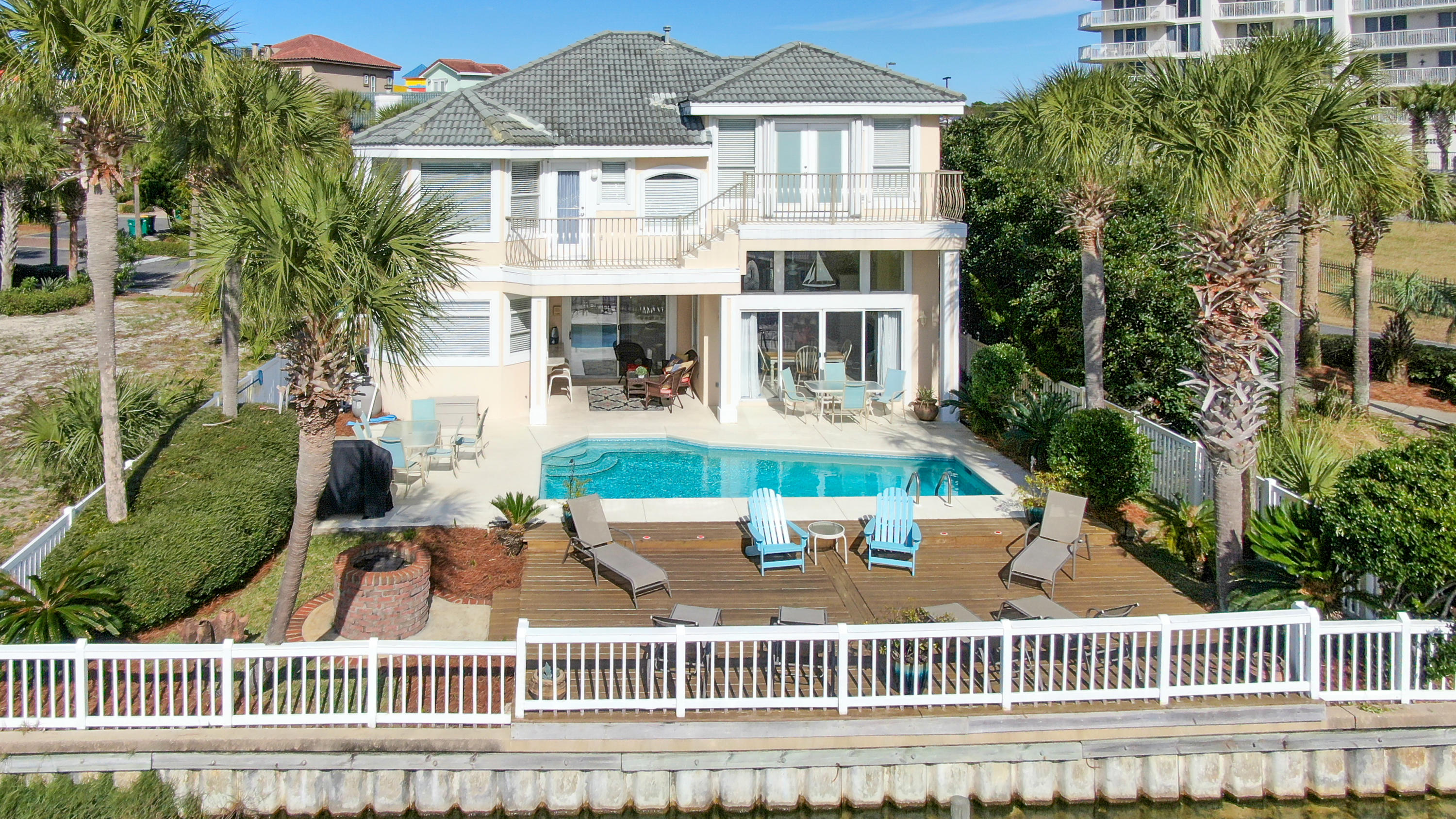 The Dunes of Destin is a gated community and one of the most desirable and central locations in Destin. Steps away from your private beach, you will find your home away from home. Evenings on the large back patio overlooking the lake and taking midnight swims in your private pool will make the vacation life all yours. This huge home is 4 bedrooms, 4 bathrooms, and sleeps 12. From the beautiful entry you will find a colorful and entertaining home. Open all the doors to let the inside and outside create a congruent and wonderful space to host friends and family. The chef's kitchen features new granite countertops, new stainless steel appliances including a gas stove, beautiful white cabinets and a breakfast bar that seats two.
