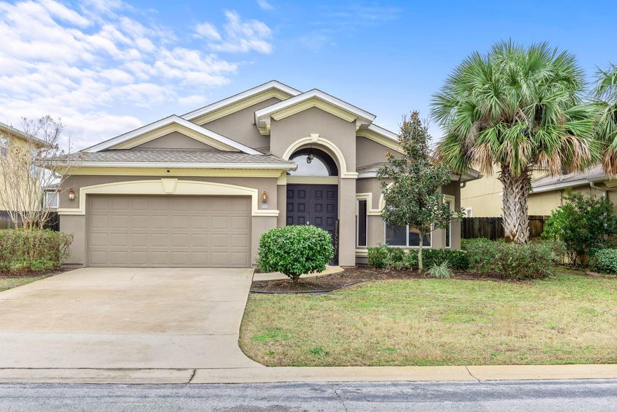 ASSUAMBLE VA LOAN 2.625%!! Exquisite stucco home in the coveted Solimar subdivision. Situated in the prestigious and tranquil Solimar community, this stunning stucco home is surrounded by picturesque, well-manicured landscaping, and mature trees. Residents enjoy a peaceful atmosphere combined with convenient access to Hurlburt, beaches, Navarre and FWB, making it the perfect place to call home. A charming double-door entry invites you into a bright and expansive interior, graced with an open and airy layout that exudes warmth and sophistication. Natural light floods the living spaces, highlighting the high ceilings, elegant crown molding, and gleaming wood floors. A stylish sitting area seamlessly transitions into the formal dining room, creating a refined yet inviting ambiance  ideal for hosting gatherings. The heart of the home is the show-stopping gourmet kitchen, a dream for any culinary enthusiast. Adorned with luxurious granite countertops, maple cabinetry, and a stunning tile backsplash, this kitchen effortlessly blends beauty and functionality. The large central island offers ample space for meal preparation and casual dining, while stainless steel appliances, including a built-in oven, elevate the cooking experience. A spacious pantry provides abundant storage, and the hop-up bar opens to the main living area, making it perfect for entertaining. The cozy main living area is designed for relaxation, featuring plush carpeting, a cooling ceiling fan, and ample room for gathering with family and friends. The home's three generously sized bedrooms are designed with comfort in mind, each offering abundant natural light and plenty of closet space. A well-appointed full-sized bathroom caters to these rooms with style and convenience. The luxurious master suite is a serene retreat, complete with his-and-her closets and a spa-inspired ensuite bath. Pamper yourself with the indulgent corner soaking tub, double vanity sinks, a private water closet, and a beautifully tiled walk-in shower with a sleek glass door. A well-equipped laundry room, featuring abundant cabinetry, ensures that household tasks are handled efficiently. Step through the sliding glass doors to a private, screened lanai, a serene oasis for year-round enjoyment. Stay cool under the ceiling fan while sipping your morning coffee or unwinding in the evenings. Beyond the lanai, the backyard offers a lush, fully fenced haven with a stunning pergola. The yard provides ample space for gardening, play, or relaxation, all within a tranquil and private setting. Offering a perfect blend of elegance, comfort, and thoughtful design. Don't miss the opportunity to experience the lifestyle that awaits you in the highly desirable Solimar community!