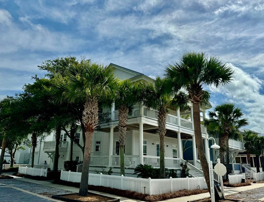 This is a lovely southern style coastal home with abundant wraparound porches for outdoor living and enjoyment. The corner lot and mature oak trees add to the beauty.  The main house has 2 bedrooms and 3 full baths with large great room/kitchen/dining open space - an entertaining dream. There is also a Carriage House with studio apartment and one car garage. This would be a great property for a second home, an investment property, or full time residence.  Enjoy the privacy of Carillon Beach's gated beachfront community with 3 pools, tennis, pickle ball, and basketball courts, green spaces for activities and 4,000 linear feet of beach.  The property is located less than a block from beach walkover #1 and the Bellview Pool and playground.   This great property is priced to sell.