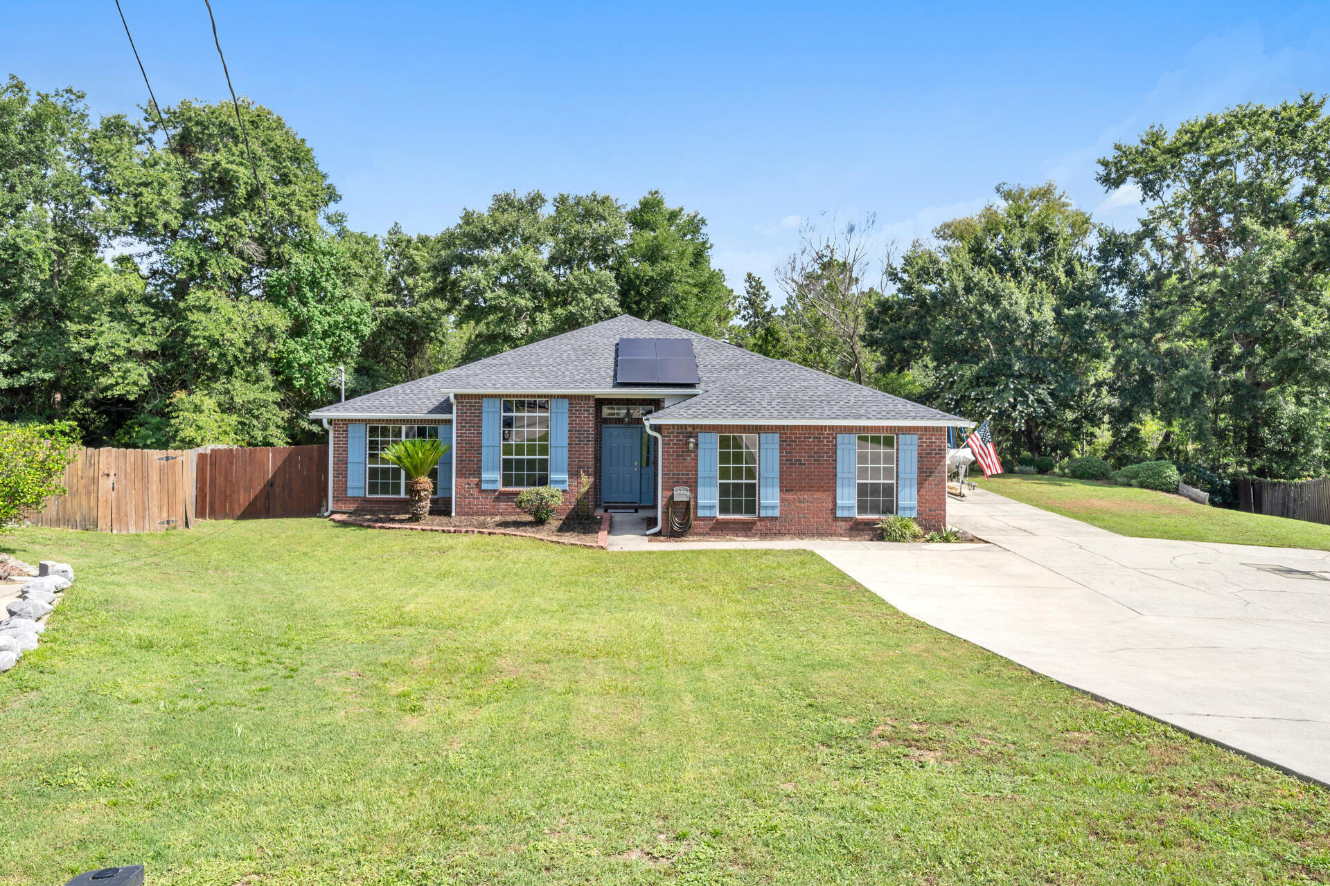 Welcome Home! This charming 4 bed, 2 bath home in south Crestview is updated and move-in ready! The roof was replaced in 2020, water heater in 2023, the HVAC condenser unit (outside) was replaced in 2025, and the HVAC air handler (inside) in 2017. In the past couple of years it has been freshly painted, most flooring has been replaced with LVP, base boards have been replaced, kitchen cabinets have been painted, living room lighting has been replace, shutters have been replaced, custom fireplace surround was added, and so much more! The living room and kitchen have vaulted ceilings and large windows that allow for ample natural light. The eat-in kitchen boasts a center island, stainless steel appliances, a pantry, & breakfast bar. Adjacent to the kitchen are the dining and laundry rooms. The spacious living room features a cozy electric fireplace, and a sliding door to the fenced backyard and multi-level deck.
Out back there are raised garden beds, a firepit, shed, and plenty of room for a future pool. Back inside, the spacious master suite includes a large walk-in closet, and bath with separate tub and shower. The oversized garage and massive driveway will accommodate multiple vehicles, with room left for a boat, RV, trailer, or other toys. The garage has pull-down stairs to the attic storage area, which is partially floored. The home features solar panels for energy savings. Close proximity to schools, shopping, dining, and approximately 40 minutes to the beautiful beaches. Located south of I-10, this home won't last long, so schedule a showing today!