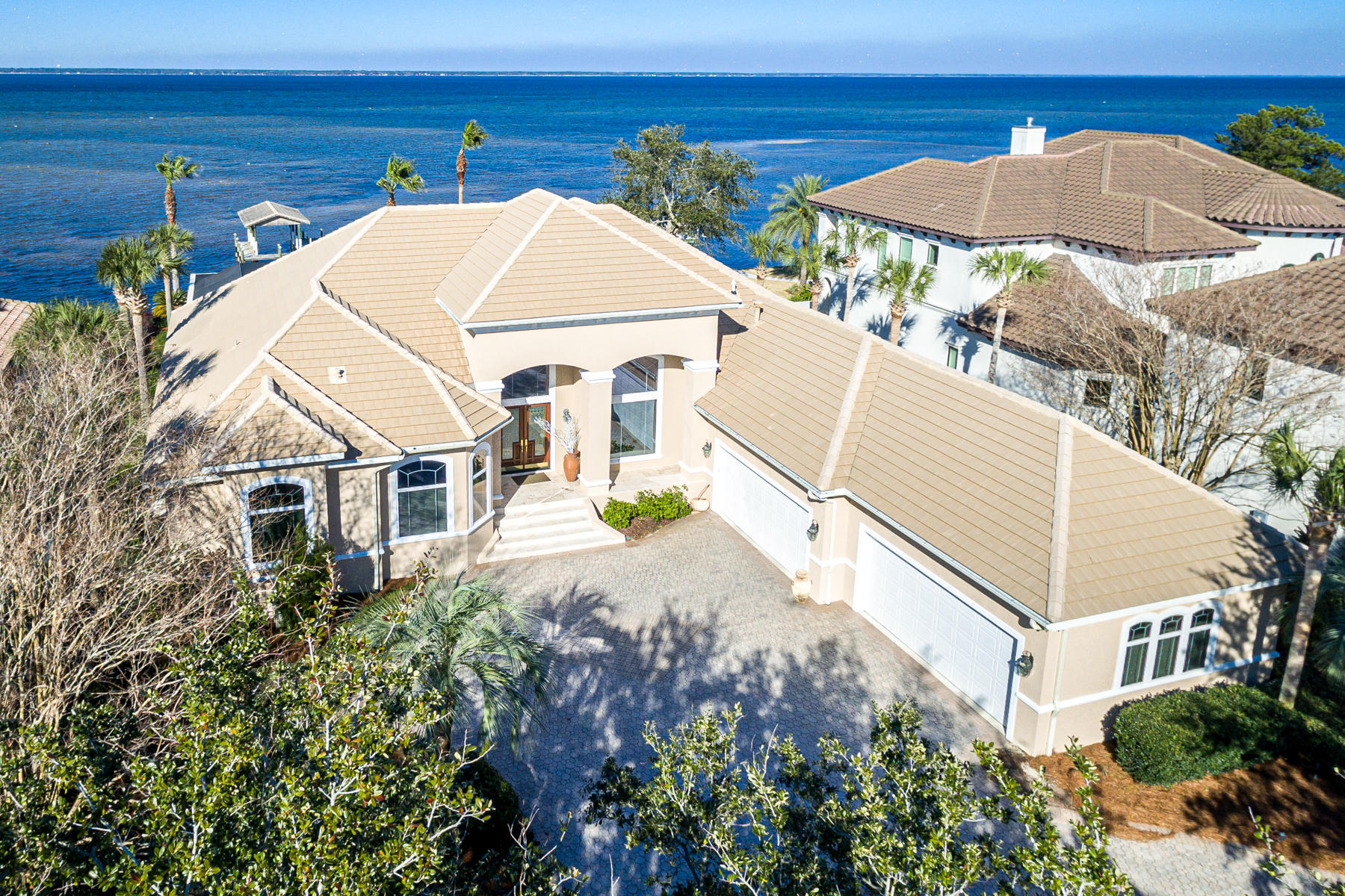 Still showing property and accepting back up contracts until contigencies have been met.Rarely on market, bay front, single-level living in prestigious Regatta Bay.  Over 100 spectacular feet of bay frontage includes private dockage and is equipped for lift equipment.  Large windows and an open-layout frame calm bay waters and blue skies for a dramatic entry.   High ceilings and updated lighting are ready for your decorative touches. A convenient screened-in lanai features a  pool, spa, and summer kitchen. The luxurious chef's kitchen combines modern conveniences and open styling for the ultimate gathering space .