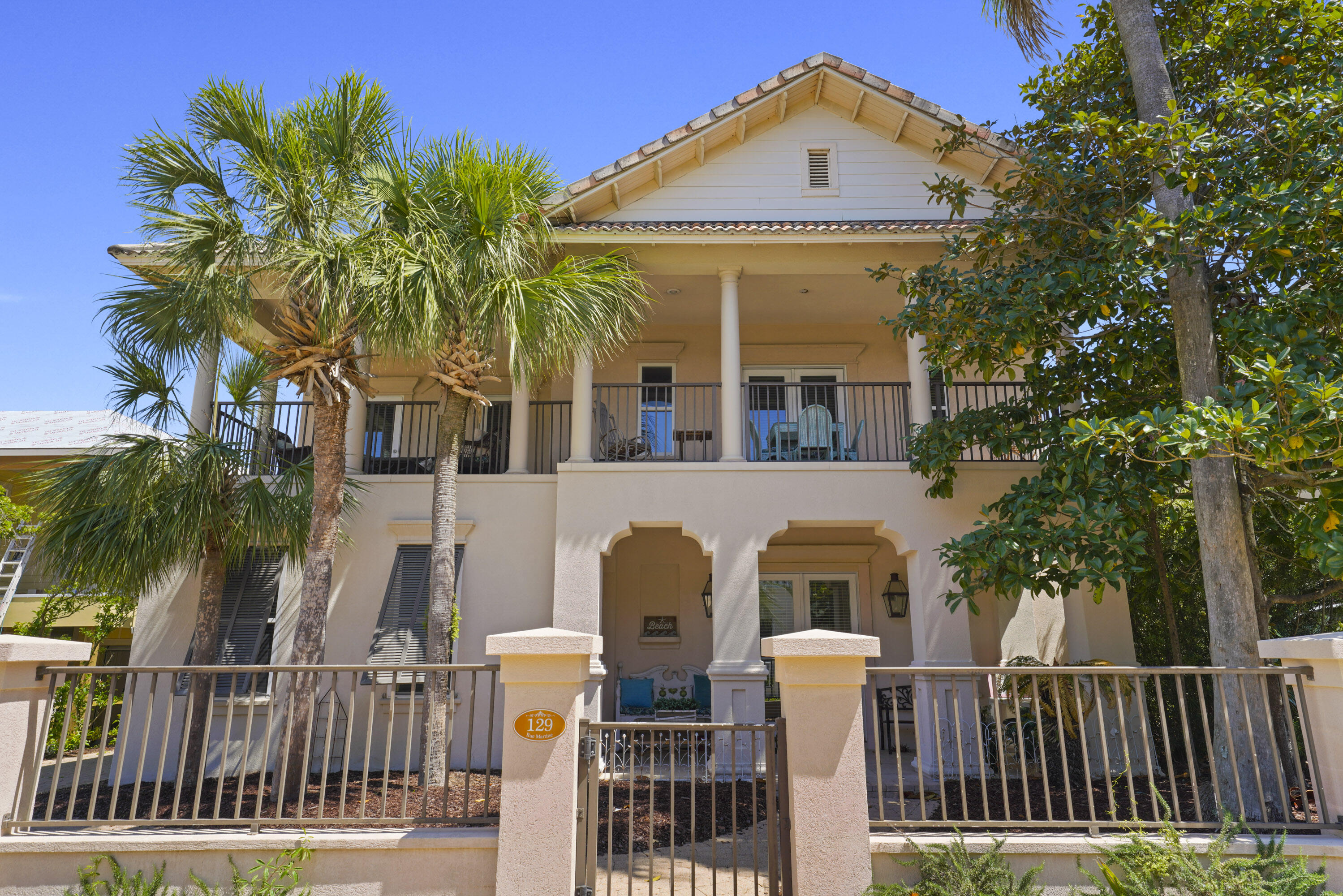 Nestled in the prominent Gulf-front, gated community of Caribe, this stunning custom home is an exceptional investment, primary or second-home opportunity. One of the few properties with a rare double-car garage, it also includes a storage room that can be converted into a rental carriage house. Inside, the open-concept first floor features a spacious kitchen with granite countertops, a breakfast bar, and a dining area illuminated by a rare Murano glass chandelier. A cozy breakfast nook, family room with a fireplace, built-in bookshelves, and a wet bar add to the home's charm. A versatile bedroom/office and full bath complete this level. Upstairs, the expansive master suite offers a jacuzzi tub, walk-in closet, and balcony access. A guest suite also opens to the balcony, along with an additional guest suite, a large bath with a soaking tub, and a cozy bunk area. 

The home is tastefully finished with natural sisal carpeting, tile flooring, and a signed Isamu Noguchi piece.

Outdoor living is just as inviting, with a full-width front balcony, a covered back patio, and a side patioperfect for relaxing or entertaining. 

Don't miss this unique opportunity to own in one of the Emerald Coast's most sought-after communities! Caribe boasts 500 feet of private beach, convenient beach walkovers, two pools (one heated), and a tennis court.

Property is sold unfurnished; however, a few select pieces of furniture may be included upon request or negotiation, chandelier in front will be changed out by chandelier sitting in the office.
