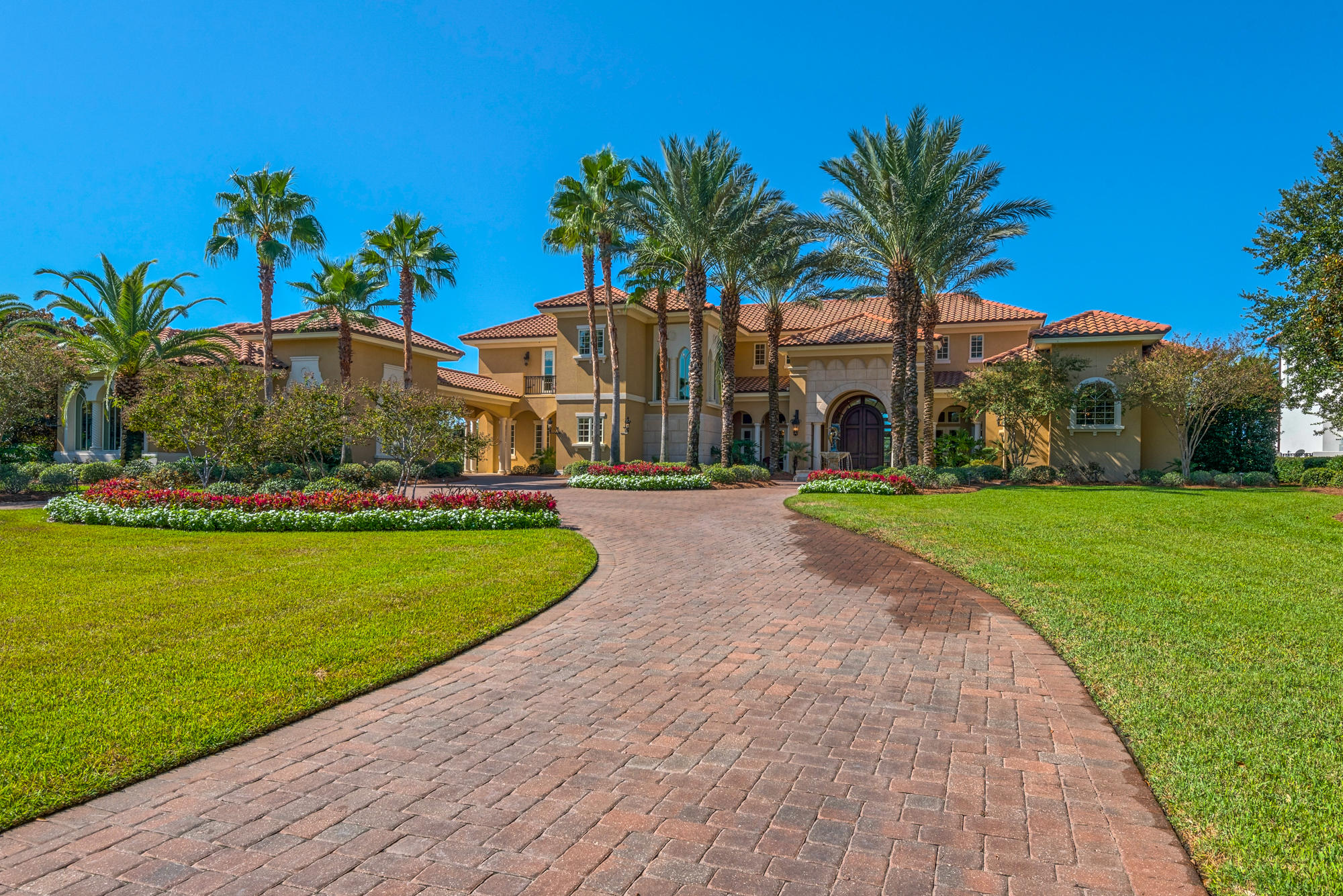 As you pull through the exclusive gates of Waterford at Kelly Plantation, you will be greeted by estate sized bayou or bay-front homesites with a serene ambiance and lush manicured landscaping - welcome home! This remarkable custom 1.02-acre estate is perfectly situated on deep water Jones Bayou with 162' of water frontage and second-to-none open Choctawhatchee bay views. Custom built with the finest of materials, latest of technology, and outstanding craftsmanship to exact specifications, this estate was constructed and designed with no expense spared. Great curb appeal with lush and vibrant landscaping with evening lighting and an insect and mosquito misting system, brick paver circular driveway with ample parking for guest(s), porte-cochre, motor court, center water feature fountain,