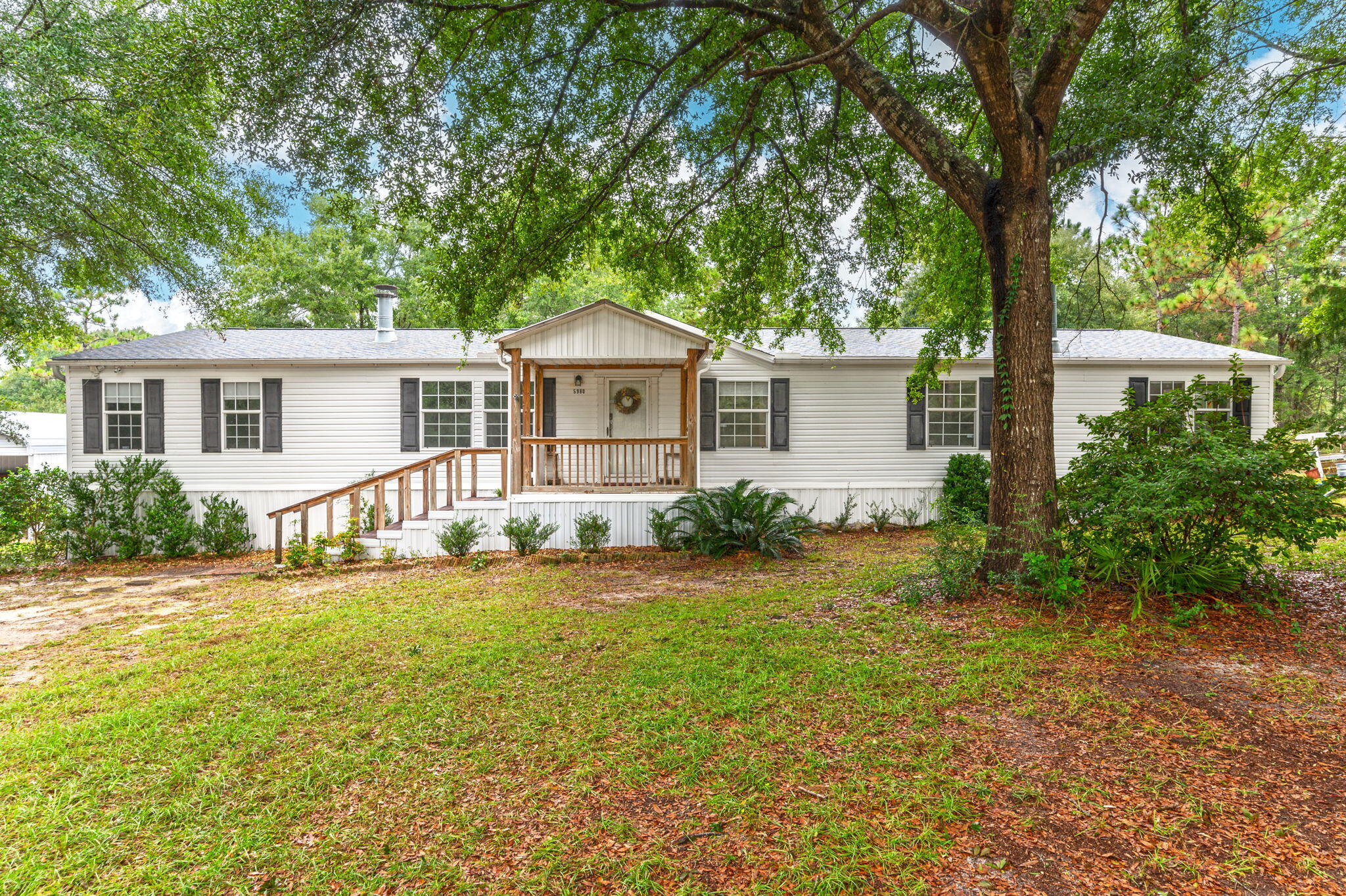 Outdoor enthusiasts paradise! Over 11 acres with a chicken coop, garden beds, plum, pomegranate and peach trees and a natural spring on the property. 4/2 bath home with a large bonus area with wet bar and fireplace. Living room has seperate stone face fireplace. Deck spans across the entire back of home with hood vent for grill or flattop. 36 foot Workshop with 110 and 220 amp. Detached carport. Pole Barn. Additional shed space that is fully cooled by a mini split unit. Would be a perfect homeschool or craft/hobby room. Fenced area to the right of home perfect for pets. Brand new roof 2024, AC 2021/2022, and fireplaces inspected 2021. Work tables/benches will remain in workshop. Separate power meter with 200amp service available at front gate of property - perfect for RV