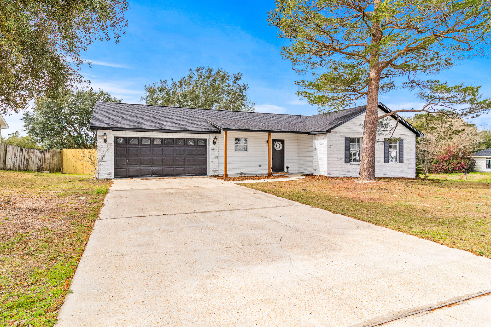 Welcome home. Charming 3 bedroom, 2 bathroom home located in desirable Navarre, FL. This recently updated house features stainless steel appliances, a dishwasher, fresh paint, and new light fixtures throughout. The property boasts a new roof, a spacious garage, tall ceilings, and a fenced-in yard for added privacy. Inside, you'll find walk-in closets, luxury vinyl plank flooring, and a convenient laundry room. Enjoy relaxing on the front porch or hosting gatherings on the back yard patio. With a storage shed and being situated on a corner lot, this home offers both functionality and style. Don't miss out on the opportunity to make this house your new home!