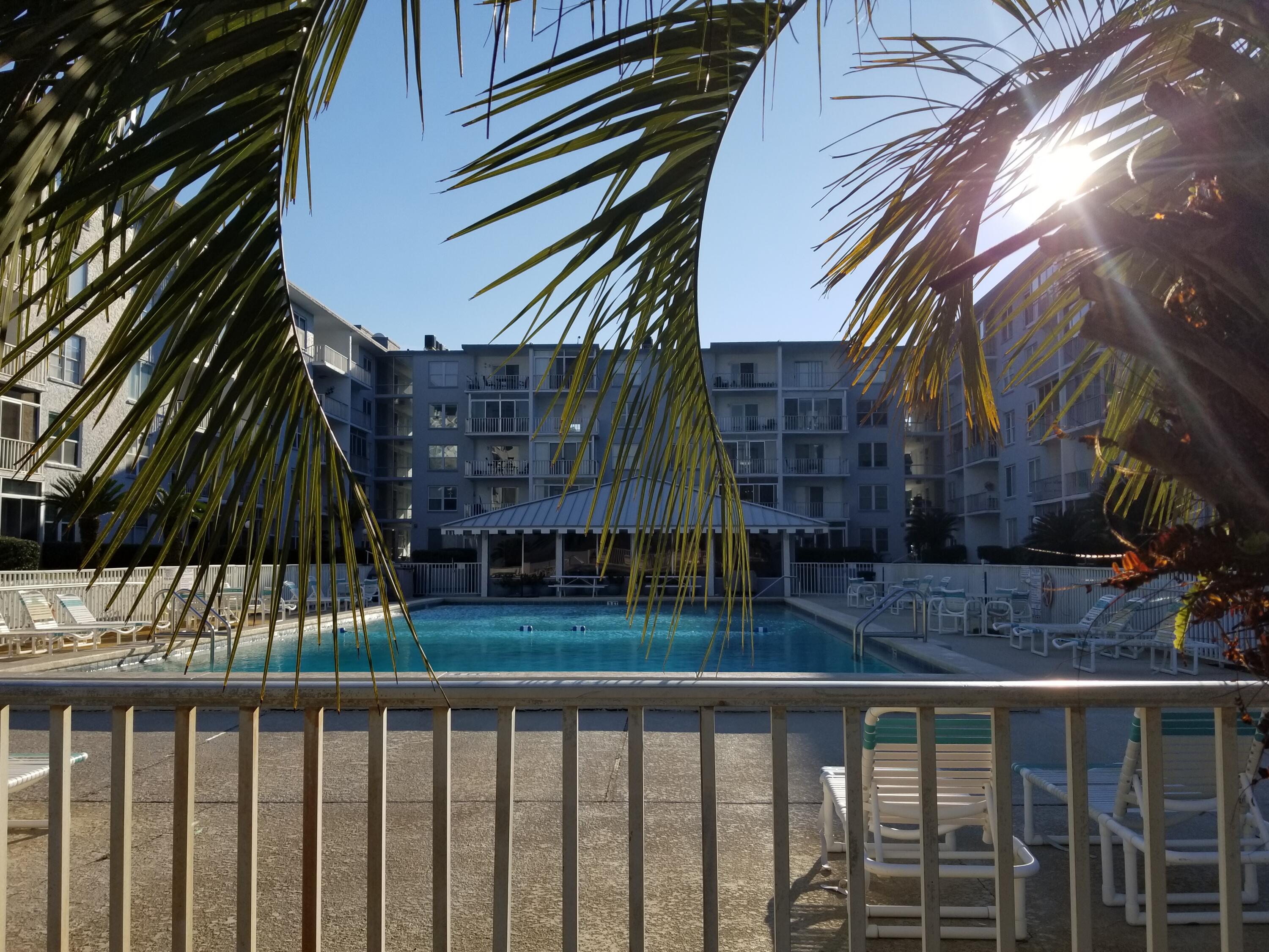 UNBELIEVABLE OPPORTUNITY to purchase this spacious one bedroom ground floor condo in the beautiful complex Century Park West in the Heart of Destin overlooking the Choctawhatchee Bay!! Convenient first floor location in building with assigned parking space right outside your front door! Interior freshly painted throughout. There are two walk-in closets, ceiling fans in living room, bedroom and enclosed glass sunroom.  Amenities include a huge sparkling inground swimming pool, convenient laundry and storage on each floor, great clubhouse, fishing dock, and more!  Well maintained grounds and complex.  Just a short drive to the incredible  sugar white sand beaches and emerald green waters of the Gulf of Mexico.  A must see condo perfect for retirement, second home, or vacation living!