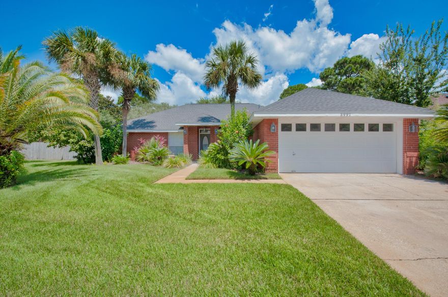 Settle into the heart of Destin in this beautiful turnkey pool home with immediate proximity to beaches, shopping, food, and entertainment. As you walk into this split floor plan brick home, you'll be greeted by an open dining and living room with vaulted ceilings, leading you to the breakfast area and kitchen, featuring stainless steel appliances, granite countertops, and ample cabinet space. This 1,895 SF floor concept includes a private office, 2 guest bedrooms, a full bath, and a two car garage on one side of the home, while the spacious master bedroom and bathroom is on the opposite. The master bathroom offers separate vanities, a walk-in tile shower, and tile floors. Two walk-in closets stand between the bed and bath.