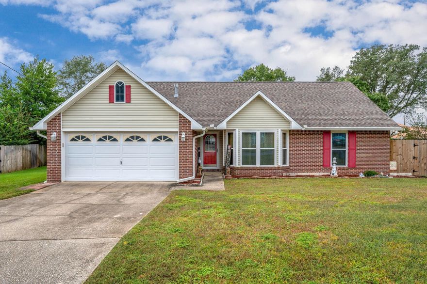 South of I-10 with no HOA, this home is a true retreat at the end of the day. Major updates--roof, HVAC, appliances, and windows--are all less than 4 years old. Inside, LVP flooring flows throughout main floor complementing a remodeled primary bath with a walk-in shower and dual shower heads.  The gas fireplace and gas range add warmth and style, while an enclosed Florida room and patio open to a privacy-fenced yard with irrigation. A large storage shed, gutters, and termite bond complete the package--modern comfort with everyday convenience.