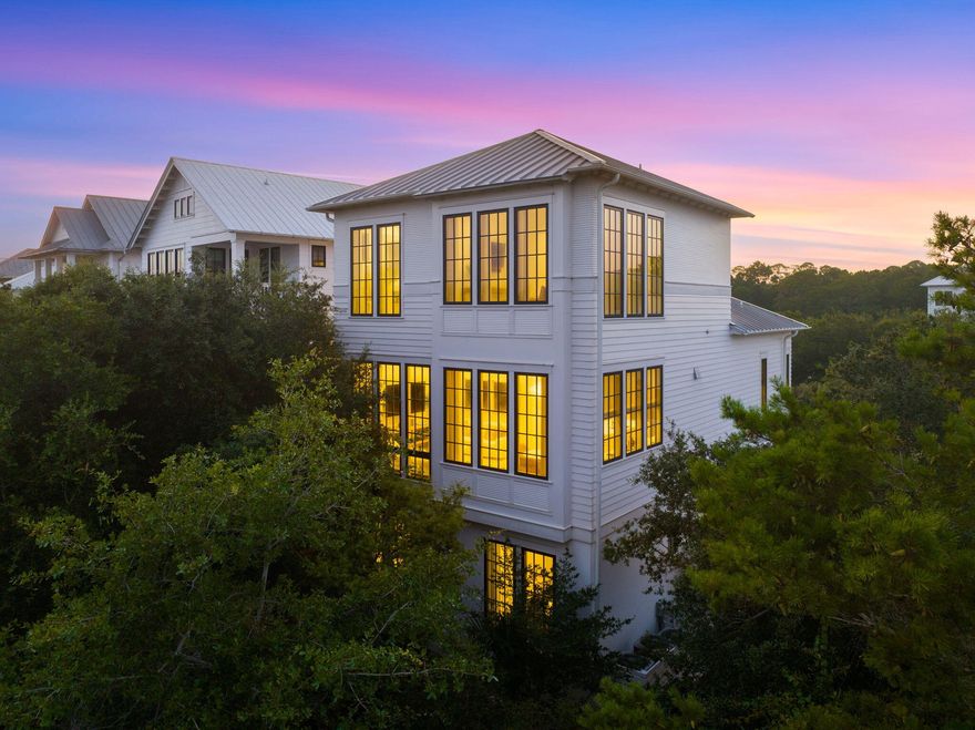 Primely positioned behind the gates of SeaNest Village in Seagrove Beach, sits 191 Sand Oaks Circle. Exclusively offered as one of only forty-seven homes within the village, this custom built 2018 residence was craftily designed by architect, Brian Stackable, and masterfully appointed by design firm, Colgan Simon. A combination that together has created the epitome of modern coastal luxury.Upon entrance to the home, your eyes are drawn to the beautiful white oak wood floors, 10' ceilings, solid-core 8' doors and private elevator. The reverse floor plan grants access to a one-car garage, a reimagined entertainment space, and guest suites along the first level.