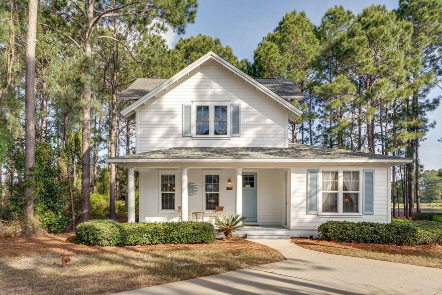 Sit on the BACK PORCH and EXPERIENCE one of the most SERENE getaways - PRICELESS! Indulge in the feeling of privacy, nestled among the trees, in the midst of popular Laurel Grove. Enjoy peaceful views from an open floor plan with soaring cathedral ceilings. Take in Lake views, as well as the first fairway and third green of the renowned Ravens Golf Course. This home is one of the few with a GOLF CART STORAGE ROOM. Third Bedroom is upstairs with full bath and walk-in closet. Kitchen has an island and breakfast bar. Well-Maintained Second Home. Stack Washer/Dryer does convey. In 2019 New Coil on inside A/C, New Ceiling Fans, New Kitchen Sink Erator Disposal, Upstairs' Windows Replaced w/Hurricane Impact Double Hung Windows, Exterior Painted, both porch steps rebuilt.