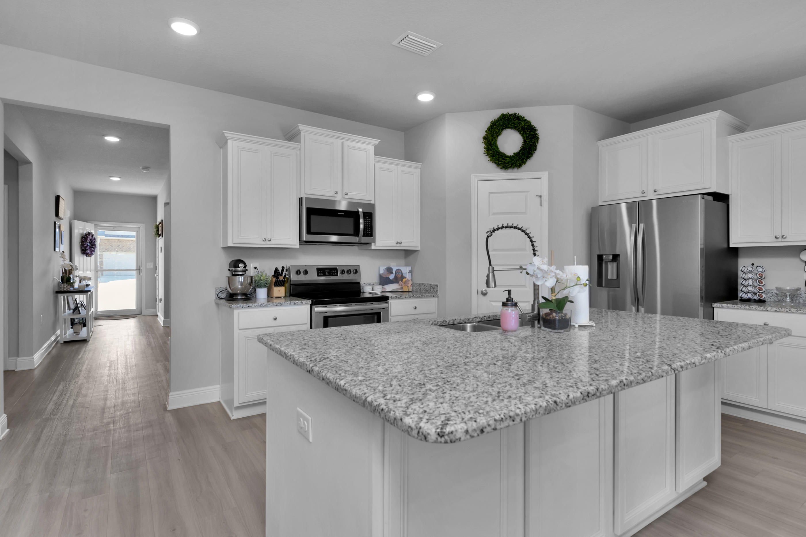 This beautiful, move in ready home is located in the popular Hawks Landing neighborhood in Pace, FL. Just minutes to I-10, Whiting, NAS Pensacola, Beautiful White Beaches and much more. The open floor plan is great for entertaining. As you enter the front door, you notice the luxury vinyl flooring, tall ceilings, and open kitchen. The kitchen features granite counter tops, stainless steel appliances and white cabinetry. The Master Suite is spacious and has a double trey ceiling. The master bath has granite countertops, garden tub and a separate stand up shower, and a large walk in closet. There are three additional bedrooms with a full bath on opposite side of house. This home also features a covered back porch over looking a private backyard