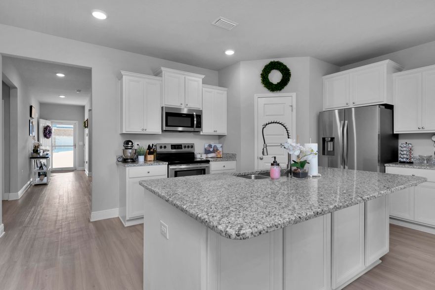 This beautiful, move in ready home is located in the popular Hawks Landing neighborhood in Pace, FL. Just minutes to I-10, Whiting, NAS Pensacola, Beautiful White Beaches and much more. The open floor plan is great for entertaining.  As you enter the front door, you notice the luxury vinyl flooring, tall ceilings, and open kitchen. The kitchen features granite counter tops,  stainless steel appliances and white cabinetry. The Master Suite is spacious and has a double trey ceiling. The master bath has granite countertops, garden tub and a separate stand up shower, and a large walk in closet. There are three additional bedrooms with a full bath on opposite side of house. This home also features a covered back porch over looking a private backyard