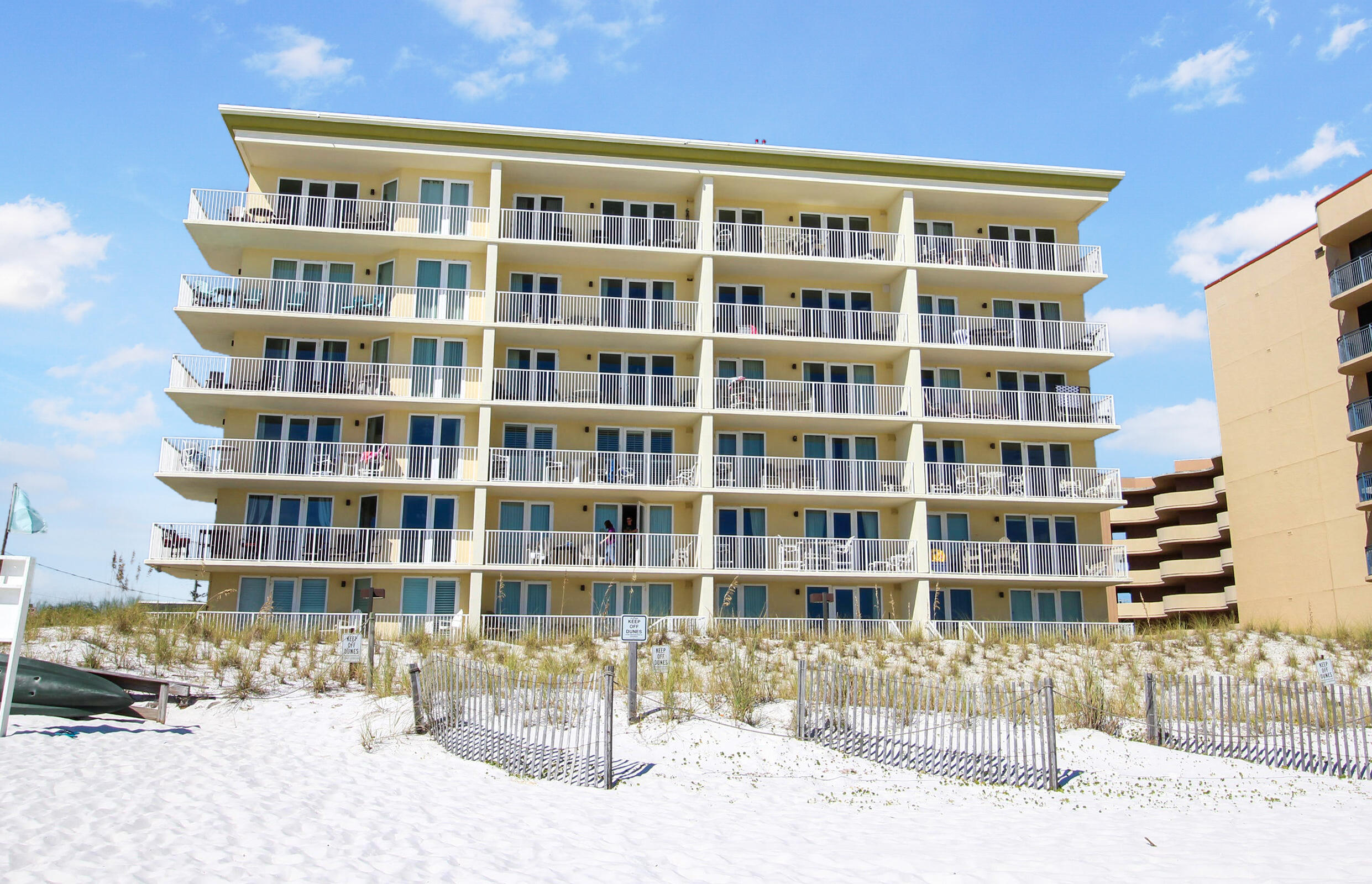 This second floor corner unit features an incredible unobstructed view of the Gulf from the living room, kitchen, AND the spacious master suite. This is the only unit at Sea Dunes that features private access to the community pool and hot tub. This would be a great unit for a family with kids - it's so easy to get to the pool or the beach from either the front door or your private balcony! Tile throughout. Bright kitchen opens into living area that features not only the balcony, but also windows with plantation shutters on the west side. Large master bathroom includes a jetted tub for relaxing evenings after a long day of playing in the sun. Two additional bedrooms and bathrooms complete this incredible package.