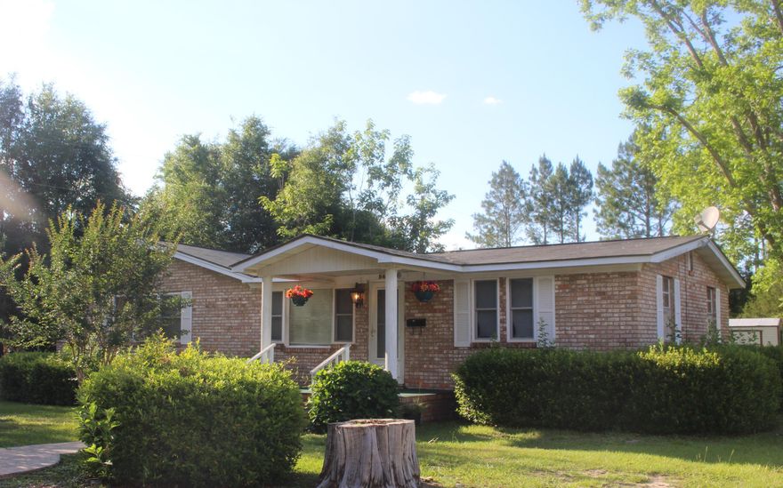 BACK ON THE MARKET!! Beautiful level 1 acre lot with 3 bd/2 ba brick home located in Holt & within 5 minutes to I-10 making this location a quick commute to several neighboring cities. The home has lots of space - a small living room as you enter the home, adequate kitchen with plenty of cupboard space & very large living/dining area complete with fireplace. The home could use some updating, but has a lot to offer...home is believed to be a Jim Walters home. Small detached enclosed space located just off rear of home which house the washer/dryer hook-up. Two portable sheds...one with carport awning. Beautiful trees & shrubs scattered about...buyer to verify all areas of importance including but not limited to zoning, school zones, dimensions, etc.