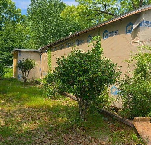 Investor Special! This 3BD/2BA home is located on a 1/4+ acre lot amongst large shade trees and a partially fenced yard. Prior to the completion of the remodel, the home had a fire near the back door area that caused significant damage to the rear of the house. Roof, Electric, HVAC, water heater, and plumbing were all done and just awaiting permits before the fire. Pictures are before the fire. Call listing associate for access. Please use caution upon entering the property.