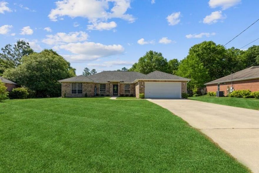 BACK ON THE MARKET AT NO FAULT OF THE SELLER. SOUTH CRESTVIEW: Large 4 bedroom - 2 bathroom, all brick home on LARGE 0.56 acre lot and pay county taxes! NEW ROOF & NEW AC in 2017. This large split floor plan offers a formal dining room, office/flex room, spacious living room with wood burning fire place, huge kitchen with island, breakfast bar, & pantry, dining area (off kitchen), indoor laundry room, and a two car garage with new auto opener. The large master bedroom offers plenty of room and bright light. The master bathroom has a double vanity, garden tub, separate shower, and dual walk-in closets. The 3 additional bedrooms & another full bathroom. The sliding glass door leads you the enormous back yard with mature trees and a large detached 13x18 workshop. This property backs up to the nature and quiet beauty of undeveloped land for your enjoyment and privacy. Take the opportunity to make this property your own by adding your personal taste and touches to this blank canvas. Schedule your showing today!