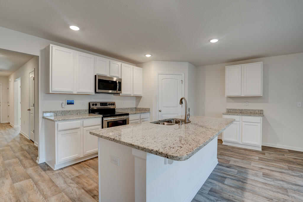 Welcome home to Redstone Commons! The seller is motivated to make a deal on this 4-bedroom, 2-bath Cali floor plan home offers a blend of comfort and style with stunning granite countertops in the open-concept kitchen--perfect for entertaining at the bar or stepping out to the covered patio for grilling. The master suite is a highlight, featuring a soaking tub and a generous walk-in closet. Privacy is ensured with three additional bedrooms on the opposite side of the home. The backyard is fully fenced, providing a safe and secure area for outdoor activities. The freshly painted, spacious 2-car garage adds to the convenience of this move-in ready home. Enjoy the exceptional community amenities, including a dog park, zero-entry pool, and playground. Don't miss out--this home is priced to sell