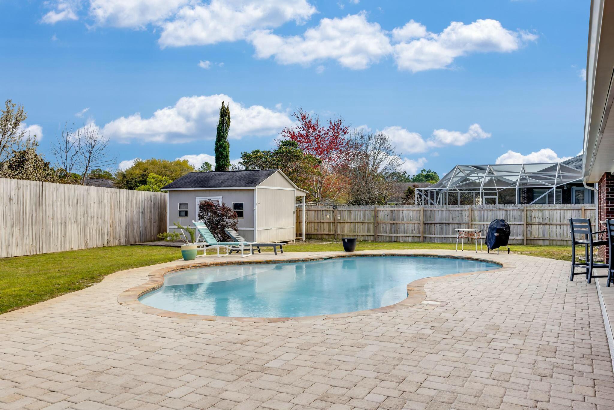Check out this beautiful POOL home - perfectly designed to fit all of your needs! The split floor plan offers privacy with 4 bedrooms and 3 full bathrooms as well as a formal dining room AND office space! No carpet here- beautiful wood look tile in the main living areas and Pergo waterproof LVP in the bedrooms. Step out back to the peaceful covered back porch, lush privacy fenced yard, and brick paver pool deck with gunite pool and tanning deck! Just in time for summer! Additional features include: NEW ROOF! Lifestyle retractable garage door screen, 50 amp RV hook up, 12x16 yard building with power, termite bond, 10ft ceilings, crown moulding, framed windows, recessed lighting, huge master closet, sprinkler system, gutters and more! Roof 2024, Water Heater 2022, Appliances 2023