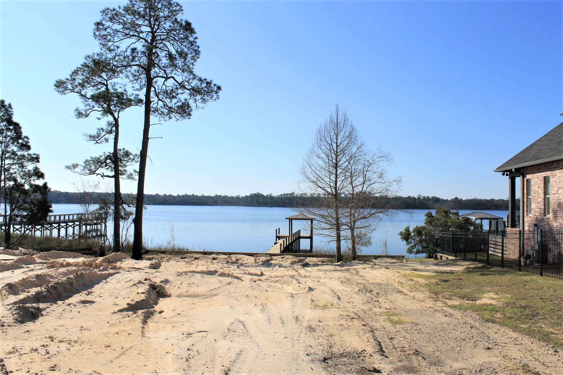 Build your dream home on the only available waterfront lot in the exclusive community of Water's Edge. Bring your builder of choice to this already cleared waterfront lot. Breathtaking views of both the sunrise and sunset from this southern facing lot on Rocky Bayou across from Fred Gannon State Park. The seller has installed custom sea wall and boat dock on this deep water lot. This development is surrounded by Turkey Creek conservation to the east and the protected bayou to the South. Water's Edge also has a Community Dock and kayak launch has well. Survey is available. NO BUILD OUT TIME!!
