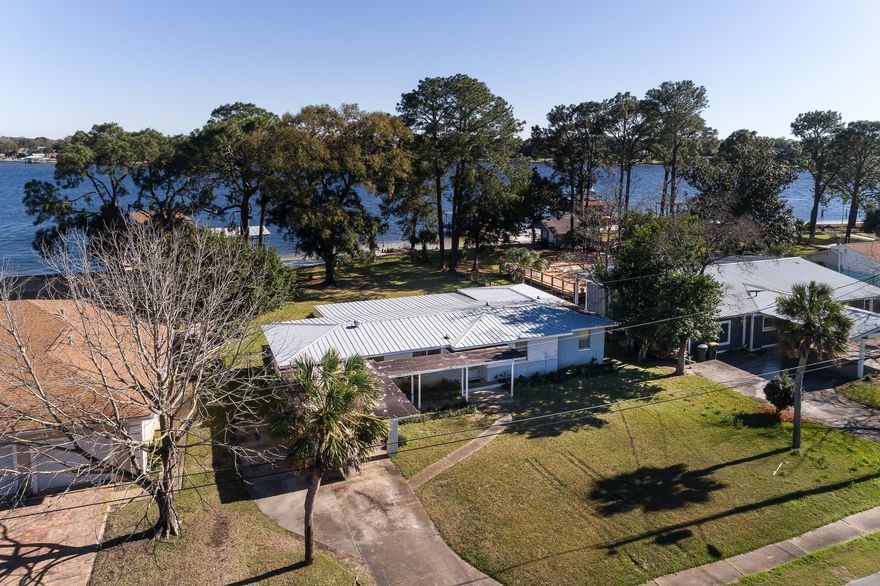 This is it! Rarely do these bayfront properties become available. An affordable opportunity to live on a large waterfront lot in central Fort Walton Beach, with a sandy beach AND in the desirable Beachview Dr. area. The foyer welcomes you in with a view straight through the living and sun rooms all the way to the bay. The kitchen enjoys a wide window letting in lots of light. The master bedroom is a nice size with a big closet and its own entrance into the sun room. The floor plan flows well and offers wide-open living space with double-door openings connecting the living and dining areas to the huge sun room - great for entertaining. The home could use updating, but it is ready for your own touches and ideas. The big back yard is ready for a pool or even a sizable addition to the home.