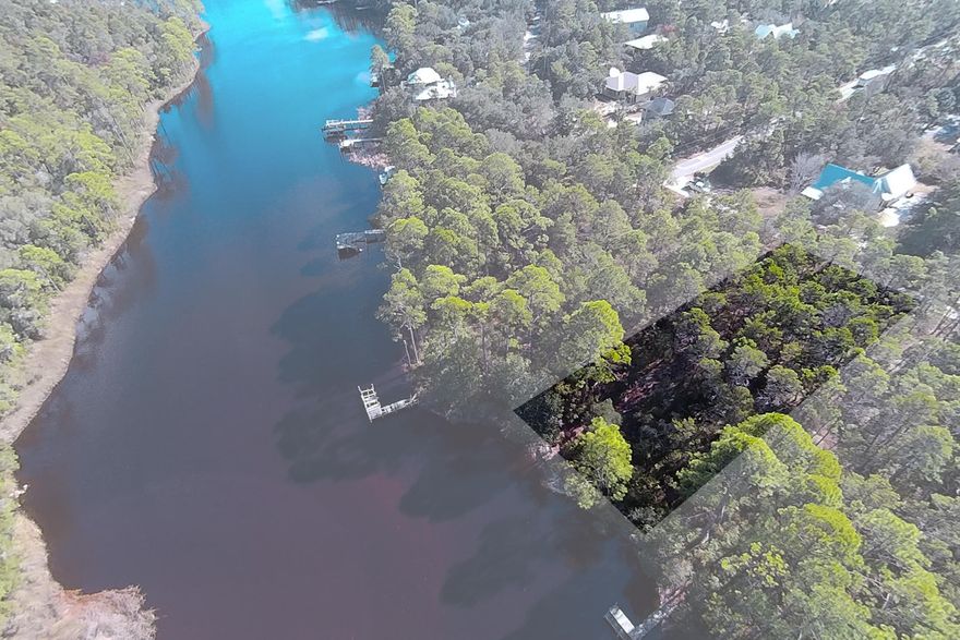 The largest of Northwest Florida's rare coastal dune lakes rests at the foot of this Inlet Beach lot. Unlike its more modest neighbors found to the west along Scenic Highway 30A, Lake Powell accommodates motor boats and allows for a wide range of activities, such as fishing and tubing, to be enjoyed on its open waters. Bringing together the best of boating and the beach, access to the Gulf of Mexico is located just under three quarters of a mile due south from this lot. The 16-acre gulf front state preservation is surrounded by plenty of parking and features just under 1,500 feet of blissful beach front.