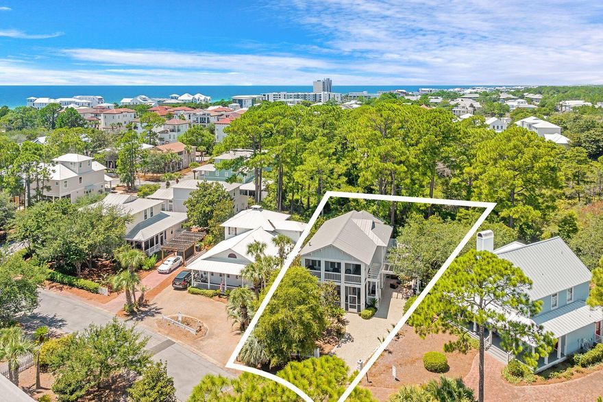 Tucked away in the desirable community of Cassine Village, this generously sized beach house is surrounded by 30A attractions in the heart of Seagrove Beach. Boasting one of the largest floor plans in the community, it offers the perfect layout for entertaining guests. One of the many standout features of this home is the abundance of multiple screened porches, which can be accessed from every room, a rare find in a home of this size. From the front porch, the front door opens into a light and airy family room with a tile floor that flows seamlessly through each designated space. Crown molding and plantation shutters add an upscale finish. There's ample space for entertaining at a dining table for eight, and the generous sitting area is perfect for lounging in front of the fireplace while watching TV. French doors open onto another screened porch, this time overlooking a spacious rear yard backing onto a wooded area. Head outdoors to fire up the $4,500 BBQ grill that's included in the sale. The well-appointed open kitchen is generous in size with beautiful double-high wood cabinets and newer stainless steel appliances, including a French door refrigerator. A large breakfast bar provides additional seating for casual meals before heading out to enjoy the beach or one of the two neighborhood pools. A spacious laundry room and a half bath are also situated on the first floor, along with an attractive master bedroom and a modern private bathroom. The second floor of the home has a large landing with gleaming hardwood flooring. The second-floor master suite has a walk-in closet and a private bathroom with a shower and a double vanity. Two further bedrooms, currently furnished as bunk rooms, share the family bathroom. The home comes with two newer HVAC units and an outdoor shower, providing additional benefits for the new owners. When built, this home included nearly every upgrade the builder offered, from finishes to fixtures, ensuring a solid and well-designed foundation. The broad paved driveway and carport can accommodate several vehicles, and there are extra storage sheds for bikes and beach gear. This generously sized Florida cottage is offered fully furnished and turnkey. Cassine Village has excellent amenities, including two community pools, tennis and pickleball courts, and a nature trail that winds through the neighborhood. With its prime location just minutes from the Gulf of Mexico shoreline and low HOA fees, this property is equally suited as a vacation home or a short-term rental investment.