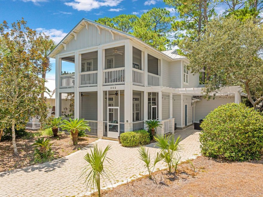 Tucked away in the desirable community of Cassine Village, this generously sized beach house is surrounded by 30A attractions in the heart of Seagrove Beach. Boasting one of the largest floor plans in the community, it offers the perfect layout for entertaining guests. One of the many standout features of this home is the abundance of multiple screened porches, which can be accessed from every room, a rare find in a home of this size. From the front porch, the front door opens into a light and airy family room with a tile floor that flows seamlessly through each designated space. Crown molding and plantation shutters add an upscale finish. There's ample space for entertaining at a dining table for eight, and the generous sitting area is perfect for lounging in front of the fireplace while watching TV. French doors open onto another screened porch, this time overlooking a spacious rear yard backing onto a wooded area. Head outdoors to fire up the $4,500 BBQ grill that's included in the sale. The well-appointed open kitchen is generous in size with beautiful double-high wood cabinets and newer stainless steel appliances, including a French door refrigerator. A large breakfast bar provides additional seating for casual meals before heading out to enjoy the beach or one of the two neighborhood pools. A spacious laundry room and a half bath are also situated on the first floor, along with an attractive master bedroom and a modern private bathroom. The second floor of the home has a large landing with gleaming hardwood flooring. The second-floor master suite has a walk-in closet and a private bathroom with a shower and a double vanity. Two further bedrooms, currently furnished as bunk rooms, share the family bathroom. The home comes with two newer HVAC units and an outdoor shower, providing additional benefits for the new owners. When built, this home included nearly every upgrade the builder offered, from finishes to fixtures, ensuring a solid and well-designed foundation. The broad paved driveway and carport can accommodate several vehicles, and there are extra storage sheds for bikes and beach gear. This generously sized Florida cottage is offered fully furnished and turnkey. Cassine Village has excellent amenities, including two community pools, tennis and pickleball courts, and a nature trail that winds through the neighborhood. With its prime location just minutes from the Gulf of Mexico shoreline and low HOA fees, this property is equally suited as a vacation home or a short-term rental investment.