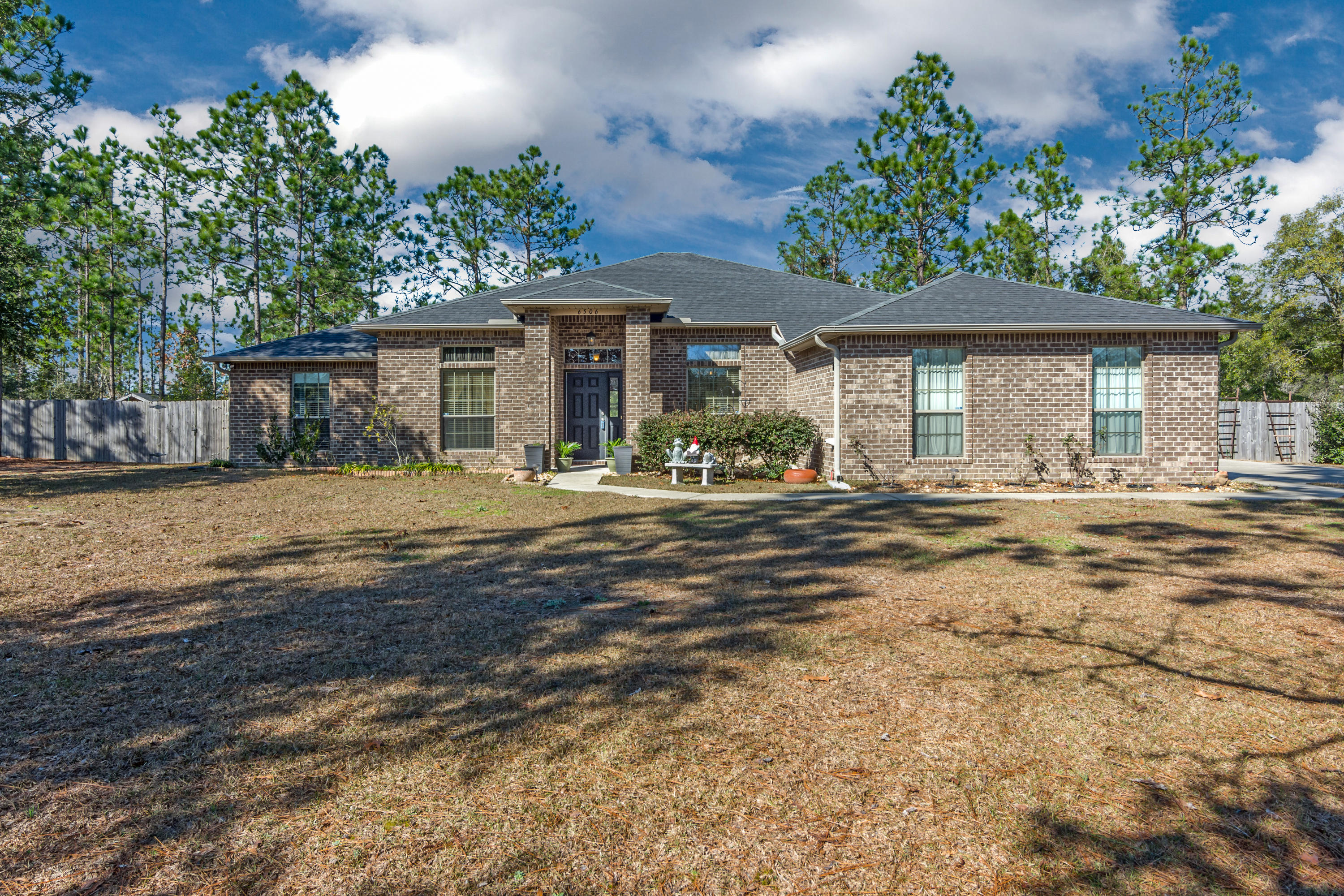 This home has so much to offer! 5 bdrs, 3 baths, sunroom, covered back porch all located on over one acre! The back yard is completely fenced and backs up to the preserve. The large sunroom overlooks the back porch and back yard. There are many upgrades throughout: 18'' tile floors, wood flooring, granite countertops in kitchen along w/tile backsplash and under cabinet lighting and upgraded lighting fixtures, security system. Located less than 10 minutes to Crestview, yet out of the traffic.