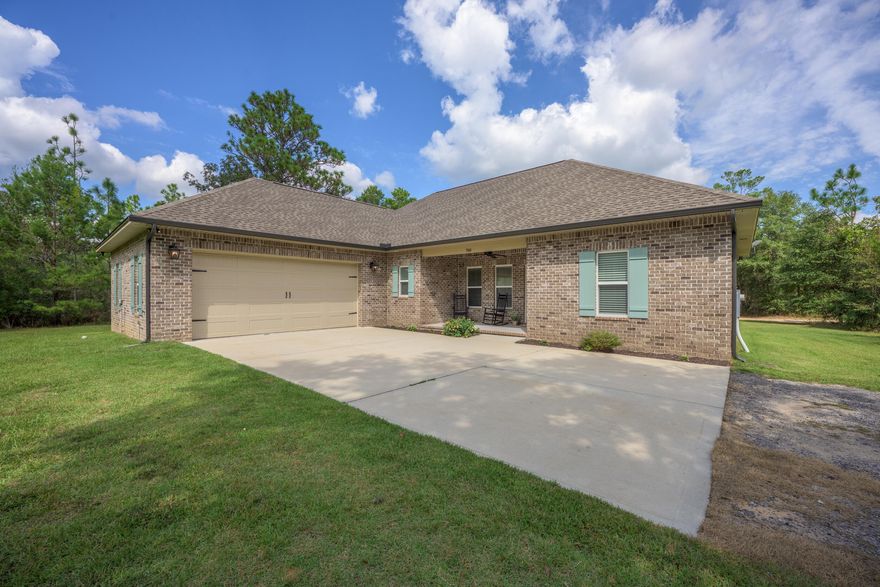 Your search is over!  Check out this incredible custom-built brick Randy Wise home. Nestled on more than 8 wooded acres, you'll enjoy the perks of country living just a hop-skip from the many things that make NW Florida the best place to call home. Stepping into this open-concept floorplan, you'll see it lives large with 9 ft ceilings throughout, adorned with cove crown molding and classic Craftsman style trimmed windows--it's giving a luxe but livable vibe. The property boasts so many upgrades and amenities--it's hard to cover all of the amazing features!  The living room is prewired for surround sound, open to the kitchen and dining area, is flooded with natural light from the large windows.  And this kitchen... Chef's Kiss! Click to read more: The kitchen blends beauty and function with a walk-in pantry and  high quality Wood Harbor cabinets--soft close doors/drawers are finished with sleek black hardware, topped with granite counters and a classic subway-tiled backsplash. Professional grade Frigidaire appliances include a 36" gas cook top, wall oven/microwave, and refrigerator with ice in the door AND a second ice maker in the freezer drawer. The massive island holds the blanco undermount sink, has seating for four nestled under the bar. The pendant lighting and island's turned legs finish the look.  The adjacent dining space has access to the covered back porch, wired for surround sound, where you'll find a gas bbq connection for grilling out made-easy.  
The split bedroom floorplan offers privacy for the massive master suite, with tray ceiling and big windows overlooking your spacious backyard. Every day will feel like a spa day in this master bathroom with an integrated blue-tooth speaker-light: Custom tiled shower with frameless glass doors, three water options--rain-head, wall mounted shower head and a separate hand held shower head on the opposite wall; high window for natural light. The master bathroom has a separate throne room for the toilet, double vanity with clean quartz counter tops and an attached walk-in closet that conveniently connects to the laundry room. Every detail comes together perfectly to create your forever dream home.
The double car garage has a upgraded 18' garage door, finished epoxy floor, workbench, wall mount for your TV and an area for you to place your dart board! Need more space--say less! There is a nice storage shed with power and an overhang out back and an additional 18 x 21 carport. It gets even better: a separate 300 ft concrete driveway with RV pad plus turnaround, power & water behind some mature trees on the far side of the property! A place to park your RV or host company without needing to adhere to a 3 day rule! Your backyard has a space ready for your firepit. Want fresh eggs? not a problem--just bring your chickens to this move-in ready coop! 

About 8.5 miles to the I-10 interchange near Hwy 90 at 285. Approx 37 miles to the sugar-white sandy beaches of Destin; Only 18 miles to Historic Downtown DeFuniak Springs. You get the best of both worlds... easy commute to shopping, restaurants, schools while living your dream in your country oasis--complete with chicken coop and mature trees on a solid, regular shaped lot with 8 plus acres! Stop dreaming about it, you've found it!