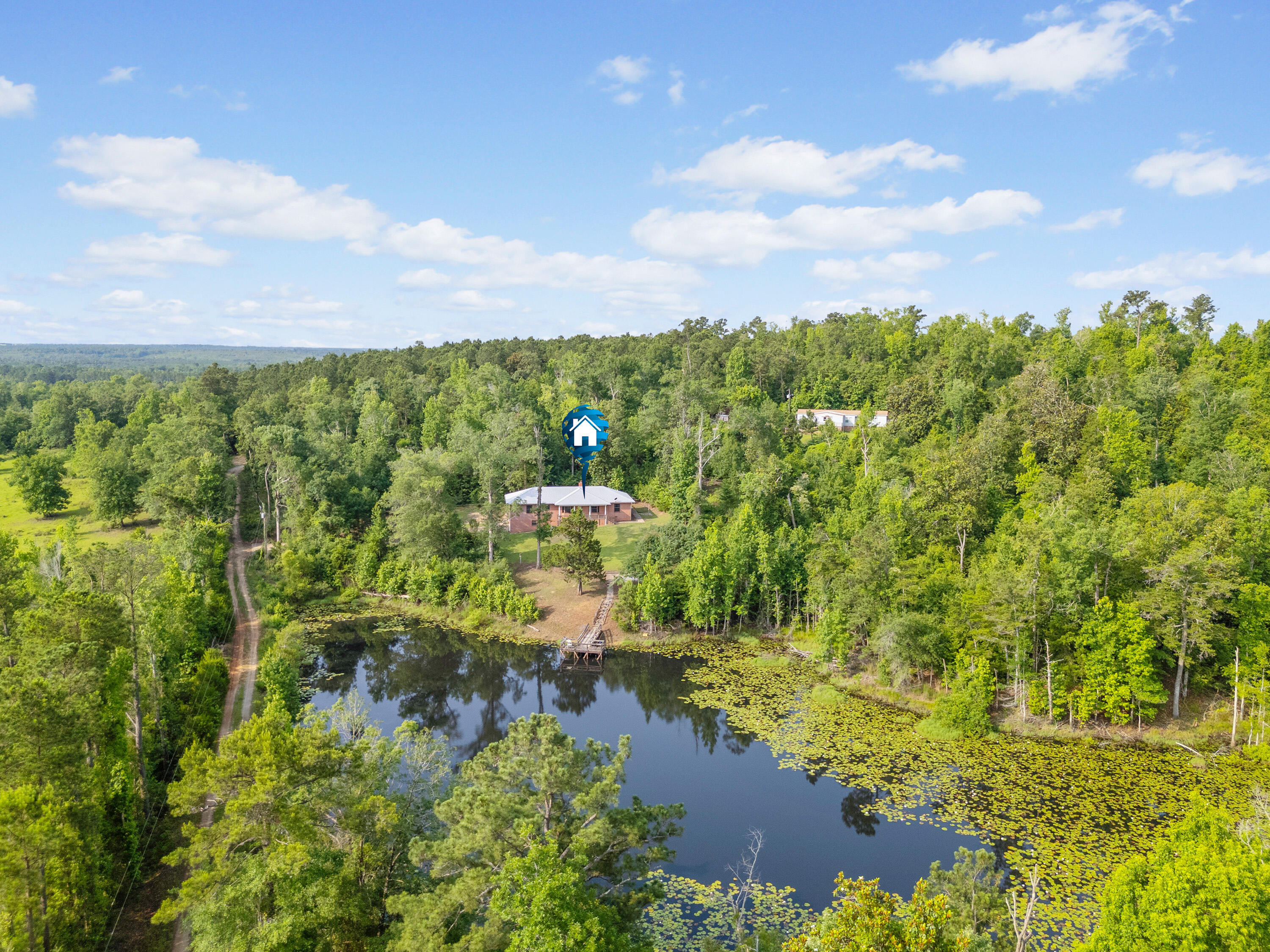 Lowest Price - 50 Acres with Stunning Features! 2 Parcels (10 acres/home & 40 Acres Land)Looking for an incredible property at an unbeatable price? This sprawling 50-acre estate is ready for the right buyer! 🏡 2200 Sq Ft Brick Home - Just needs cosmetic updates! 🏞 1.5-Acre Bass-Fed Pond - Complete with a dock for fishing or relaxing. & Attached 900 Sq Ft Garage - Extra space for storage or projects. & 3 Beds, 2.5 Baths - Spacious 2100 Sq Ft home. & Metal Roof & TLC Needed - A solid structure with potential! Includes 2 Parcels: & 10 Acres with Brick Home - FOLIO #00000000-00-0043-0003 📍 40-Acre Parcel Behind - FOLIO #00000000-00-0077-0000& Sold As-Is - Priced to Sell! Don't miss this rare opportunity!