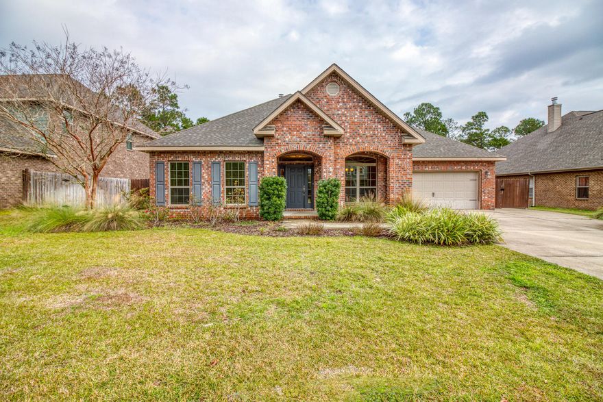 This incredible 5 Bedroom home is sure to impress with its spacious double split floor plan. This inviting brick home has an office (flex room) and formal dining room situated at the home's entry. Two bedrooms and a full bath are located at the front of the home. At the rear of the family room there are two more bedrooms and another full bath opposite of the master retreat. This floor plan is well designed for privacy and flow. The family room is open to the large kitchen and boasts finishes like hand scraped engineered wood floors, a fire place, and a double trey ceiling. This home is complete with so much storage! The view of the woods provide a serene back drop to enjoy the oversized covered porch and private yard. Make an appointment to see this private oasis today