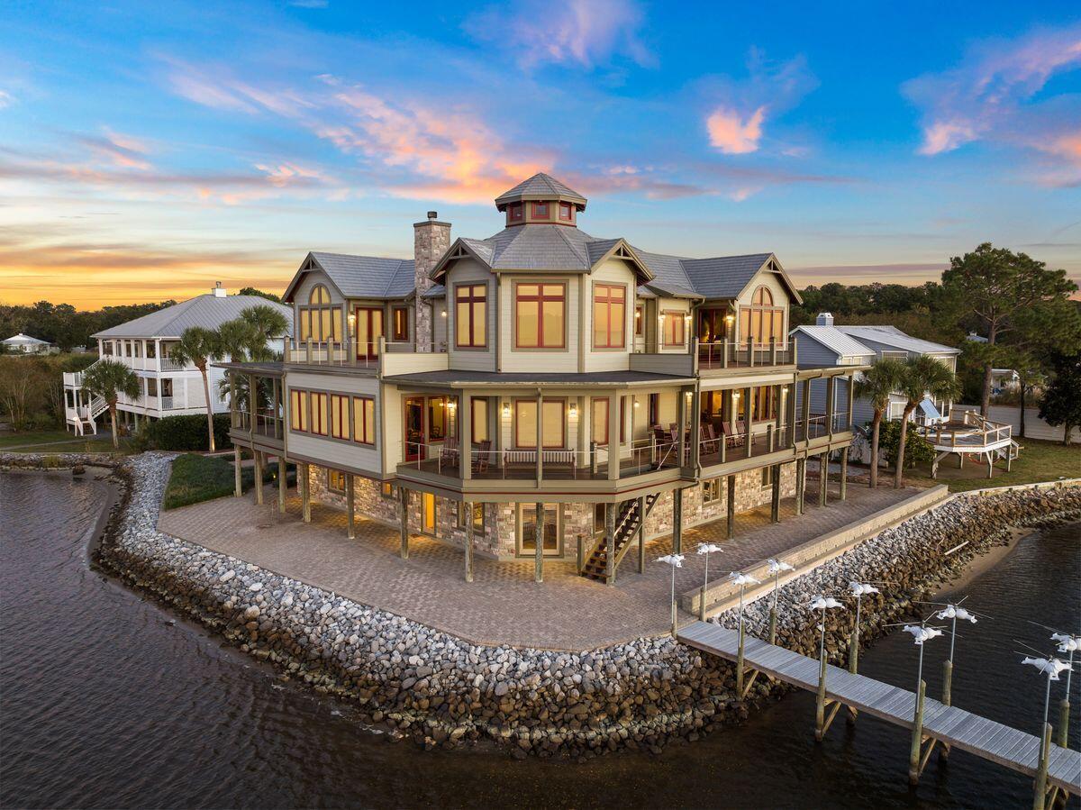 Discover the perfect blend of Craftsman architecture and natural beauty in this exceptional one-of-a-kind home featuring 300' of breathtaking bay frontage, a private dock, and a separate boat house. This thoughtfully designed custom home was lovingly created as a retreat by the owner, a physicist and engineer by trade. Perched on a scenic promontory, the home's western orientation provides mesmerizing sunset views over Choctawhatchee Bay and tranquil canals. Inside, a commercial-grade mahogany-lined elevator effortlessly connects the first floor to the upper levels, including direct pantry access for ultimate convenience.The climate-controlled lower level features a spacious two-plus-car tandem garage, a versatile multi-purpose room, a workshop, and a generous guest suite, perfect for entertaining or accommodating visitors. Don't miss the opportunity to own this remarkable bayfront retreatschedule a showing today!