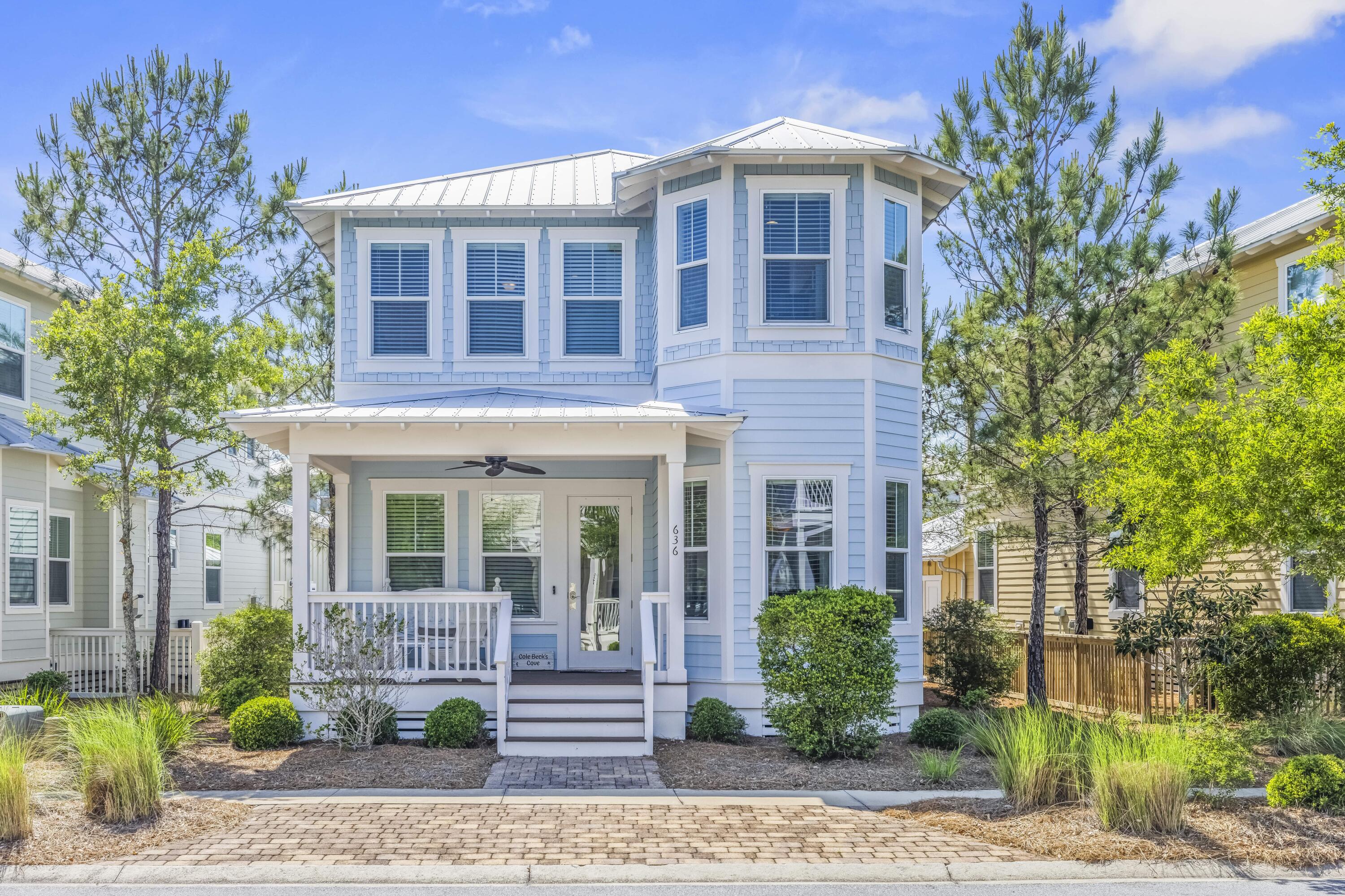 Welcome to Cole Beck's Cove at NatureWalk, where charming design meets comfortable coastal living. This unique rental features a turreted corner, a cozy covered front porch, and an inviting, cheerful exterior. Inside, the home is designed for comfort and style with casual furnishings, modern amenities, and tropical-inspired decor.The open-plan living area is filled with natural light and offers a relaxed, airy atmosphere. A pastel blue leather couch and matching loveseat face a large TV, creating a perfect spot for unwinding. Just steps away, the dining area features a round table in a cozy alcove, accented by four straw-backed chairs beneath a glowing amber chandelier. Additional seating is available with four woven bar stools at the kitchen island, which looks out to a fully-equipped kitchen with stainless steel appliances.
The first floor Primary Suite is an ideal retreat, with a king-sized bed and a luxurious private en suite bathroom. An open staircase leads to the second floor Guest Quarters, where you'll find two elegantly decorated bedrooms with queen sized beds and private bathrooms, plus a charming Bunk Room for kids. There's also a small den off the bedrooms with a flat screen TV for added relaxation, and one of the guest bedrooms even has access to a private balcony.
This exceptional home offers an inviting blend of comfort and coastal charm, perfect for a relaxing long-term stay. NatureWalk at Seagrove is popular among guests and full time residences as it's tucked back within the borders of Point Washington Forest yet just a bike ride away from Seaside and a quick 5 min bike ride down the beach trail to the beach access. NatureWalk has many amenities within the community including The Gathering Place with 2 pools and spa, along with fire pit and grills for dining with friends. Also the community has a pickleball court, playground, fitness station, and miles of trails. Come check it out.