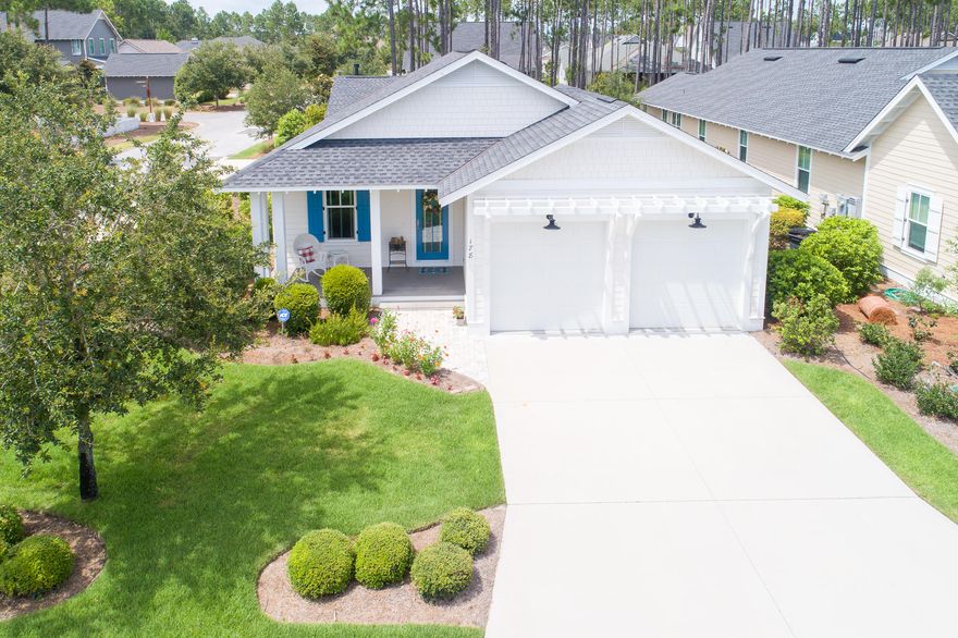 Popular Bayberry Plan with study situated on premium corner lot. Medallion wood flooring throughout and natural stone Travertine in bathrooms. Upgrades to the home include vented fireplace, 30'' Wolf Gas Range with stainless vent hood, under counter lighting, quartz countertops, dry bar with beverage center, and utility sink. Sizable Owner's Suite with spa bath, including separate tub and shower and double vanity. Large, screened porch overlooking fenced in back yard with paver patio, leading to walking trails. Easy access to amenities such as golfing, Village Commons Pool & Fitness Center, and Lake Powell.