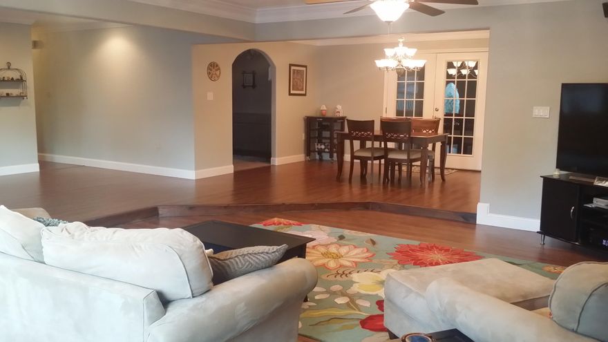 Are you looking for your ''WOW'' HOME? Look no further..HERE IT IS! HUGE Open living area greets you. Features recessed lighting, duel ceiling fans and surround sound. Large window seat in front of windows has hidden storage. Opens to dining area & really cool kitchen w/ all appliances in place. TWO Master Suites here! Through your French doors into your Den/Rec room w/ 1/2 bath. Built in wet bar. This Large Master suite has AWESOME Bath. Dark wood laminate and 20'' tile flooring thruout. Spanish lace texture on walls and ceilings. Large crown moldings. Covered area between home and ''Man Cave'' or just great workshop. Fenced backyard. Large inside utility room w/ washer & dryer in place. Tons of storage areas here. Home Warranty provided & termite bonded. Convenient location. View today!