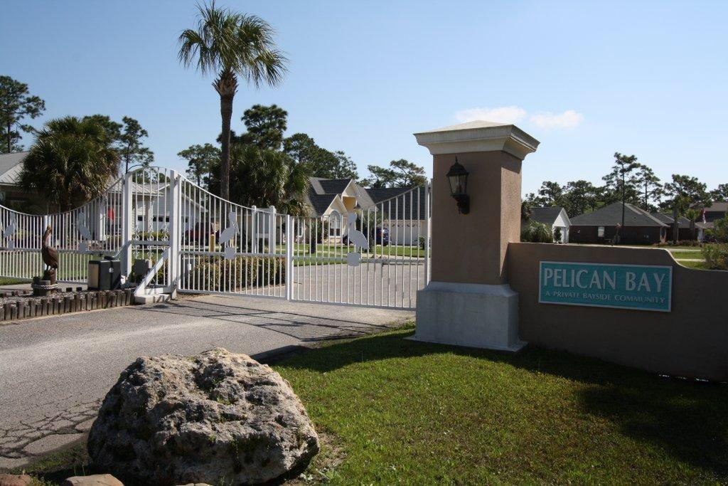 Beautiful BAY VIEW from this beautiful lot in Pelican Bay. Pelican Bay is gated subdivision located just minutes from shopping, restaurants, movie theaters and the beach. Owners in Pelican bay enjoy playing tennis on the owners tennis courts, picnicking in bay front picnic area or fishing off the dock. You can enjoy this too - Come build your dream home in Pelican Bay - NOW. Buyer to verify dimensions if important.