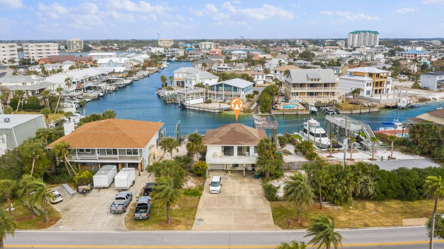 Fantastic opportunity to own an oversized deep water canal front lot in the heart of Destin! 509 Gulf Shore Drive is situated across the street from the beach, and is a short walk, bike or golf cart ride to the neighborhoods deeded beach access. Perfectly situated in the turn of the widest canal in the harbor, the property offers a 35' alongside dock, and 2 separate upland slips complete with seawall that are able to accommodate boats in excess of 40'. This truly is an incredible opportunity to build your dream waterfront residence on this unique lot, or renovate the existing home and take advantage of everything Holiday Isle has to offer. Buyer must verify all information and specifications.