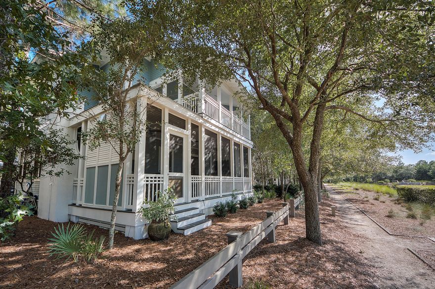 This home is custom designed for full time living by Dungan-Neugette architects and has three levels of exceptional living space. Located directly on the popular Wood Fern park in Phase II of Watercolor, this home is ideal for families wanting to take advantage of the fabulous park and pool located in the back yard. The main floor consists of a large open living space with a gourmet kitchen with Dacor Professional appliances. Beautiful custom cabinets with glass tile back splash and marble counter tops. Living area has built in fireplace and seat benches for additional storage. Off the main living area is a nice dining room with picture window looking out to the park. There is a full built in bar for entertaining. There is also one bedroom downstairs with full bath The back porch is what sells this house.  The porch is screened in and has  a built in gas fireplace, 42 inch TV.  There is a built in Hibatchi Grill in the island and cedar cabinets with beverage cooler, a DCS gas grill, and a professional Backwoods smoker built in.  This is an outdoor kitchen that any person would be envious of.  The second floor consists of three bedrooms including the master. Each bedroom has its own bathroom with custom tile work that is expected in a home of this caliber. Off the master is an upstairs media room complete with built in wet bar. The master bedroom has a large porch that fronts the park, large master bathroom with custom tile work throughout. extra large master closet. third floor is the perfect playroom/bedroom/ bunk room with full bath. This house also includes a separate carriage house that is unique to front loaded lots. This is a two story guest house that has a full bedroom and bath on the second floor with a separate living room on the first floor. carriage house is over 550 sq.ft. Oak wood floors throughout. Listing Broker/Salesperson has ownership interest in the property.